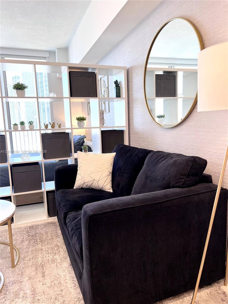 1750 N Bayshore Drive, #1218, Miami, Miami, FL 33132 Textured wall treatment and neutral color palette featuring an oval wall-mounted mirror