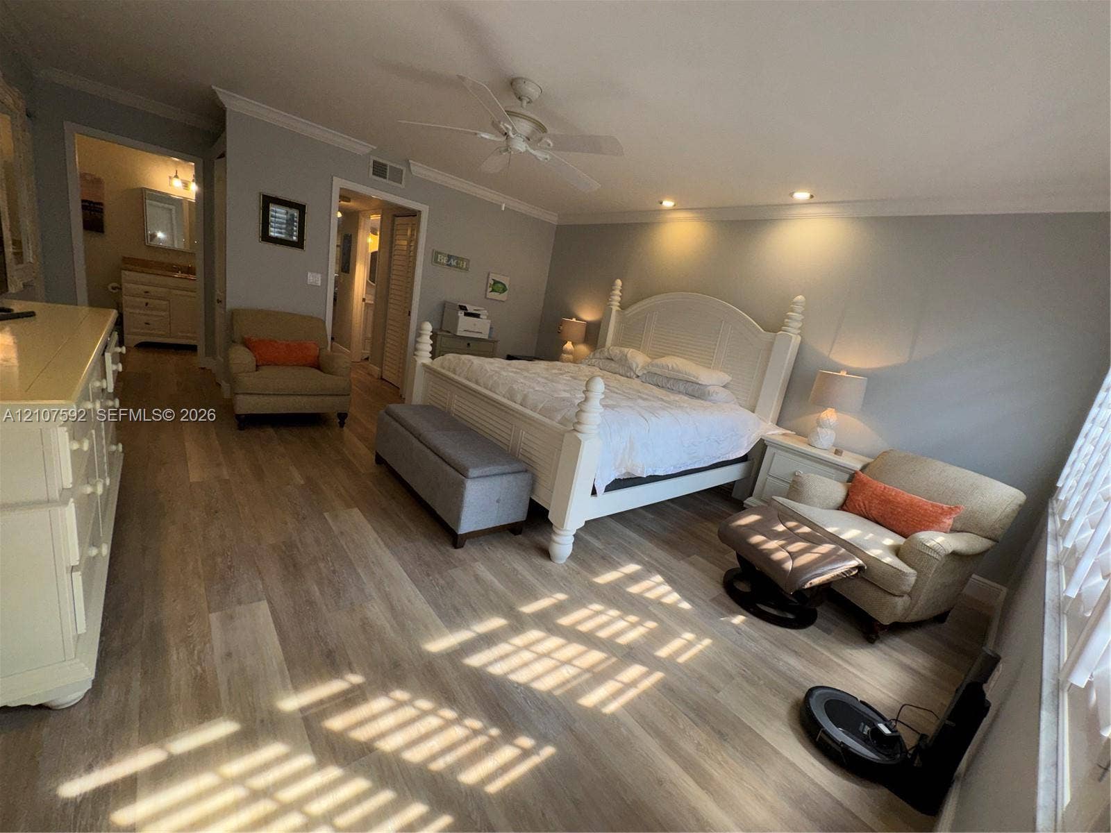 Wood-finish flooring, recessed lighting, ceiling fan, and crown molding