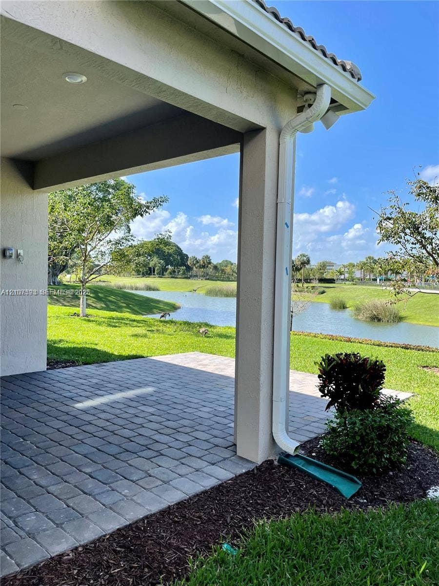 Covered patio with paver flooring, recessed ceiling lighting, and exterior water frontage
