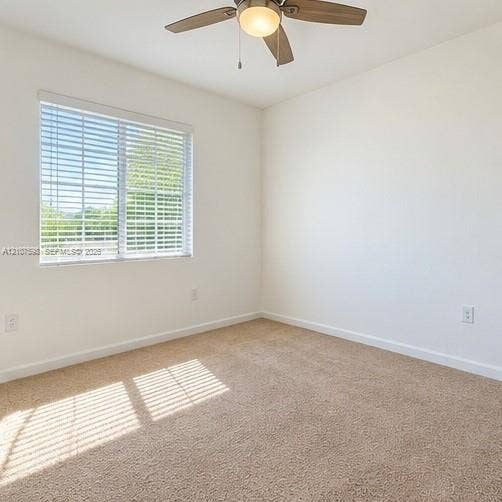 1088 NW 208th Terrace, Miami Gardens, FL 33169 Neutral-toned wall-to-wall carpeting, window with horizontal blinds, and a multi-blade ceiling fan with a central light fixture