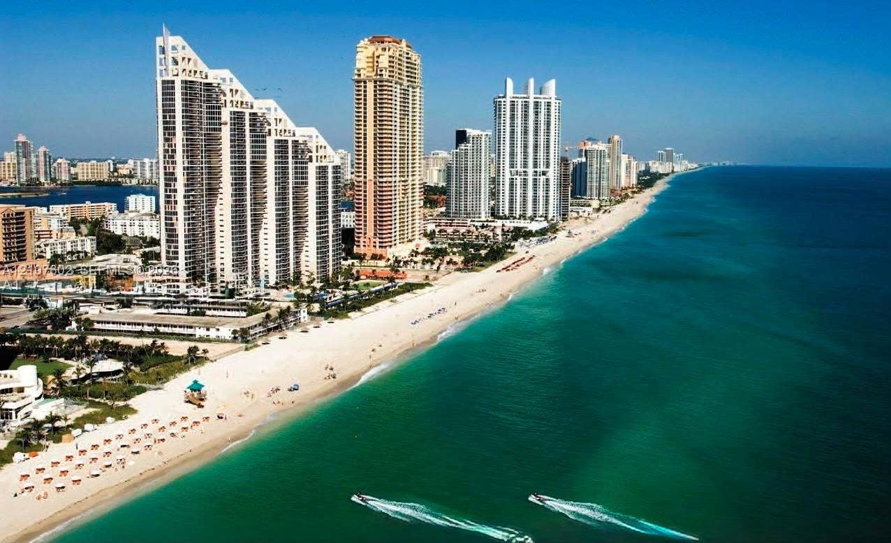 210 172nd Street, #542, Sunny Isles Beach, FL 33160 Aerial perspective of coastal high-rise development featuring direct oceanfront access, sandy shoreline, and expansive water frontage