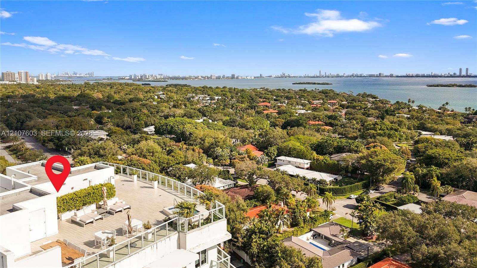 4250 Biscayne Boulevard, #1418, Miami, FL 33137 Expansive rooftop terrace featuring neutral tile flooring, glass perimeter railings, and a built-in spa