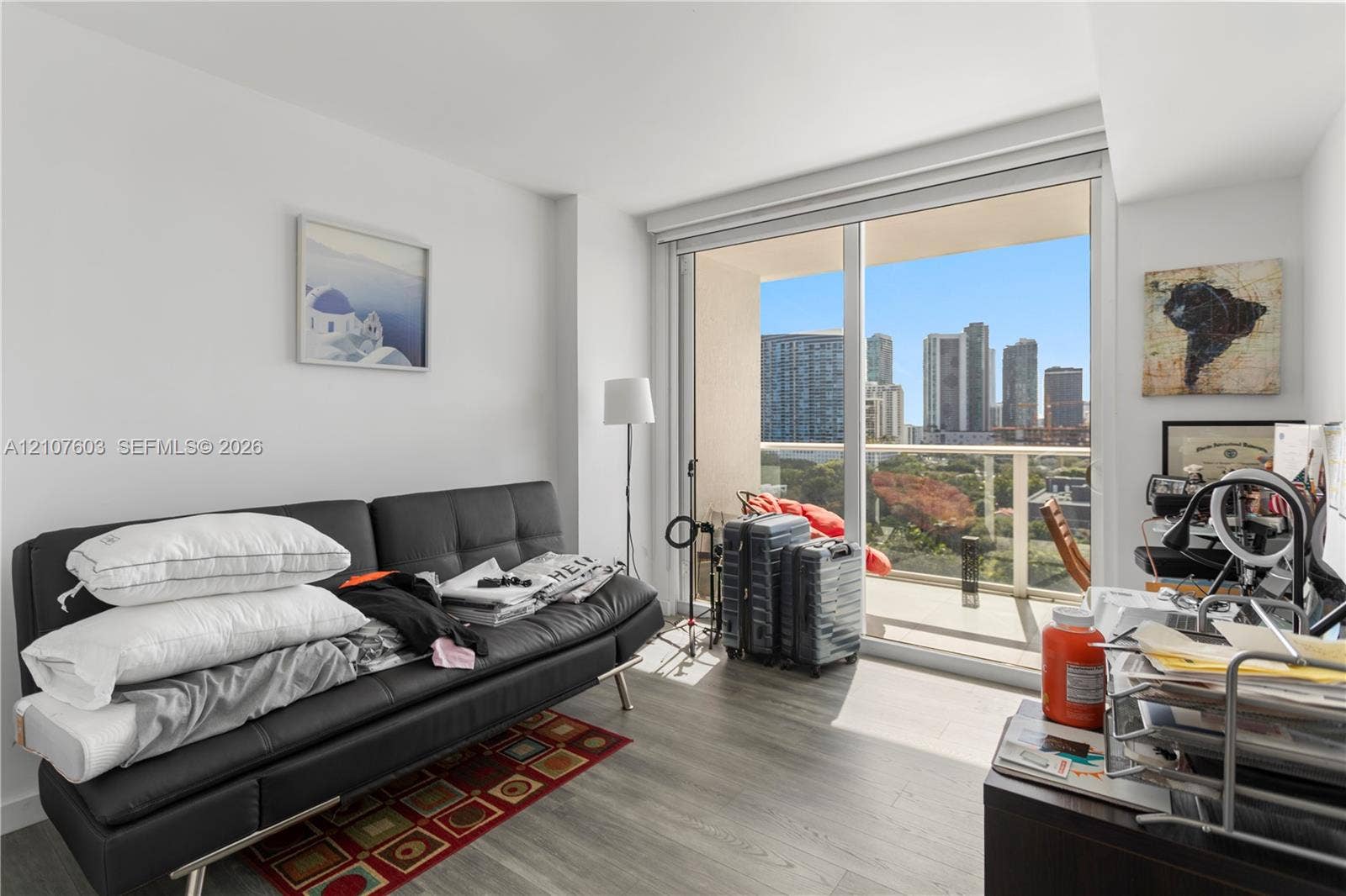 4250 Biscayne Boulevard, #1418, Miami, FL 33137 Floor-to-ceiling sliding glass door, private balcony with metal railing, and wood-finish flooring