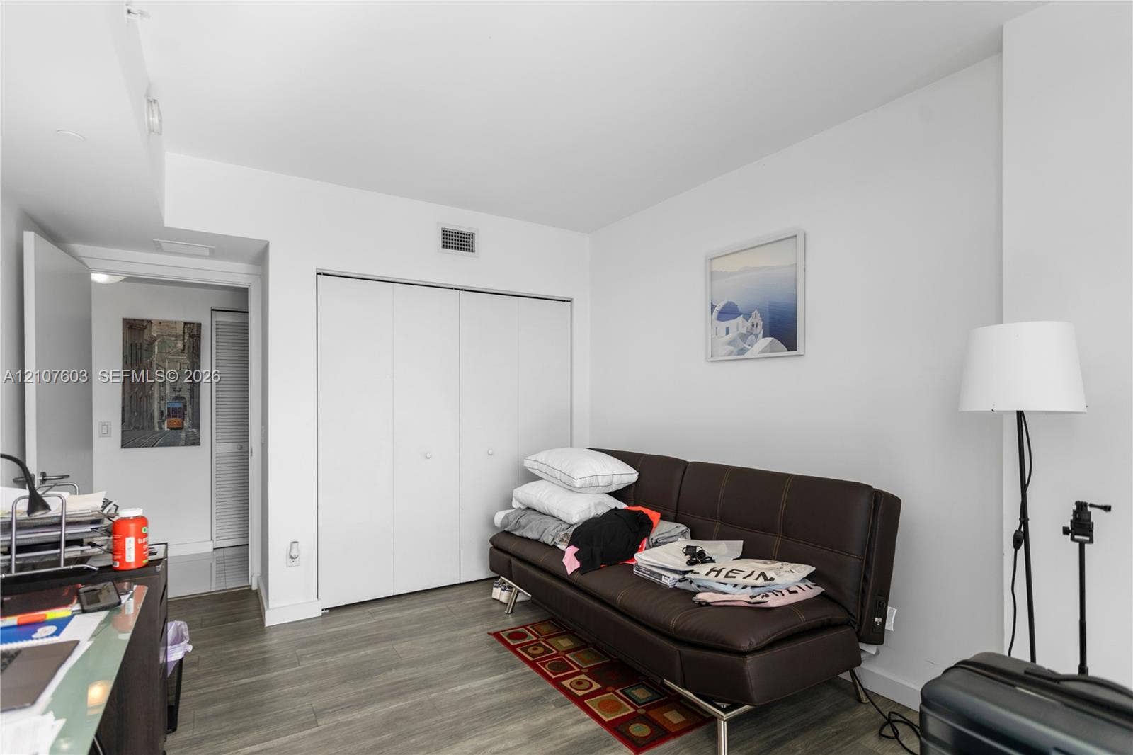 4250 Biscayne Boulevard, #1418, Miami, FL 33137 Neutral interior space featuring wood-finish flooring and floor-to-ceiling bi-fold closet doors