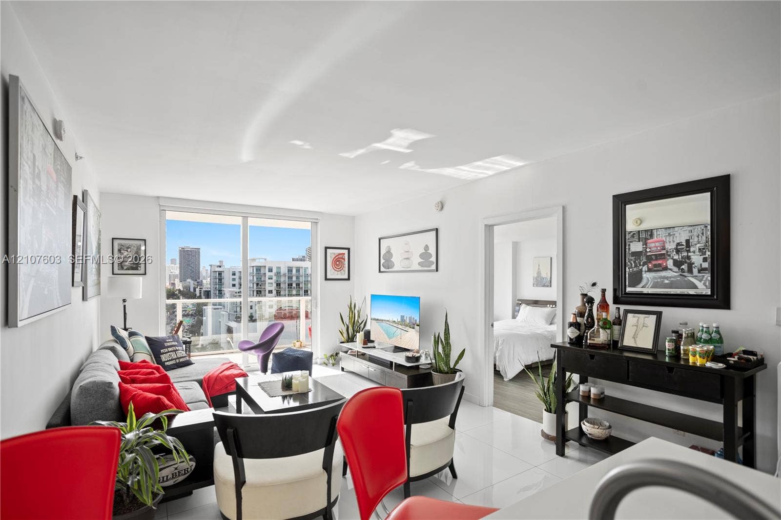 4250 Biscayne Boulevard, #1418, Miami, FL 33137 Living area featuring polished tile flooring, floor-to-ceiling glass sliding doors, and a private balcony