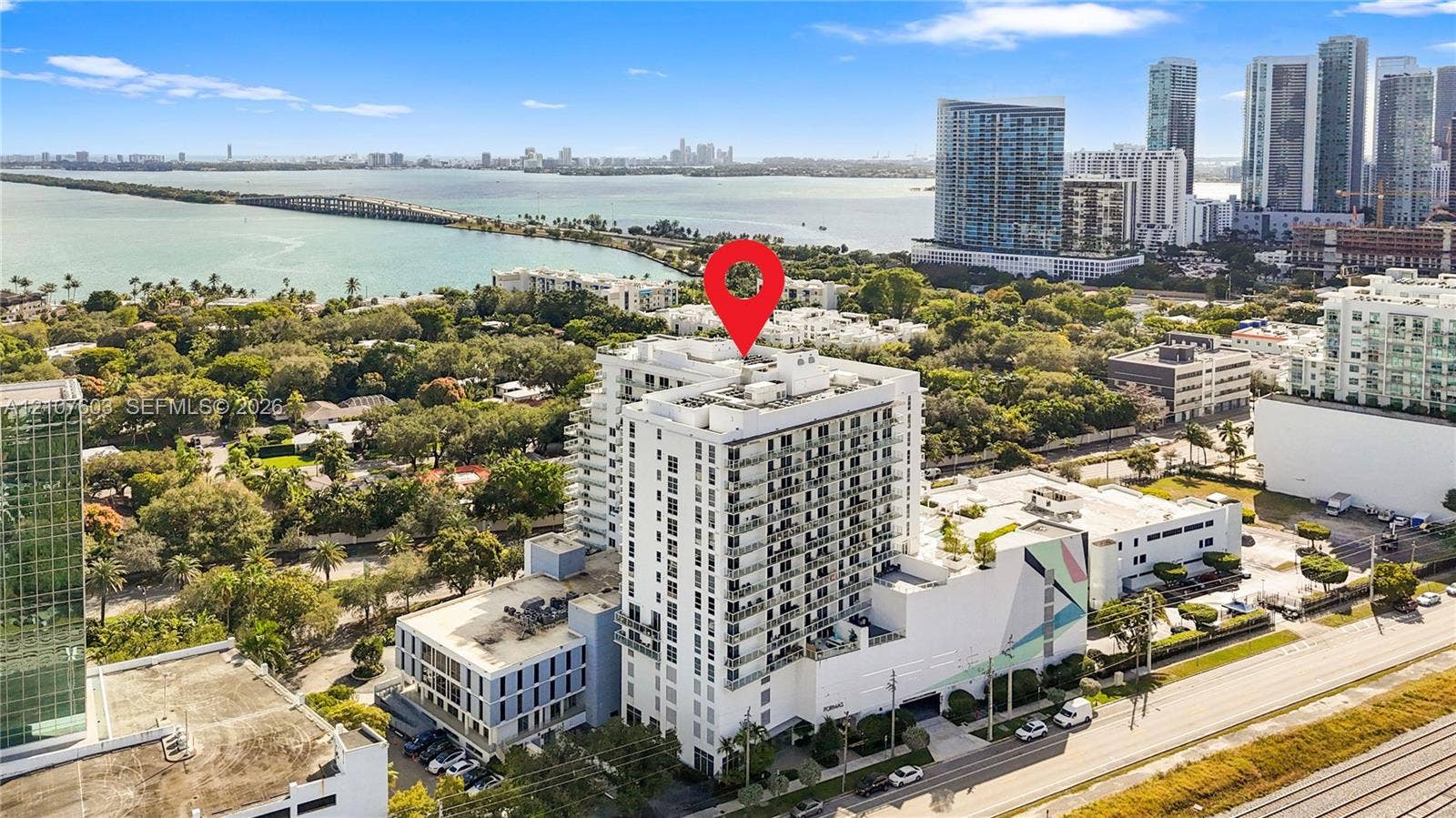 4250 Biscayne Boulevard, #1418, Miami, FL 33137 Aerial view of high-rise building featuring a white facade, glass-fronted balconies, and a multi-level architectural structure