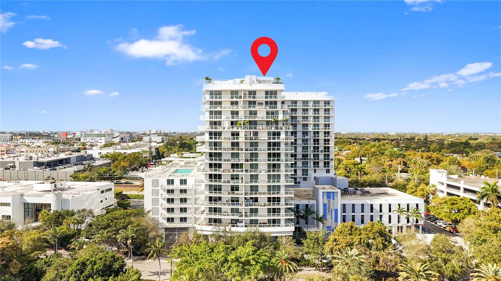 4250 Biscayne Boulevard, #1418, Miami, FL 33137 High-rise residential building featuring expansive private balconies, floor-to-ceiling glass windows, and rooftop amenities