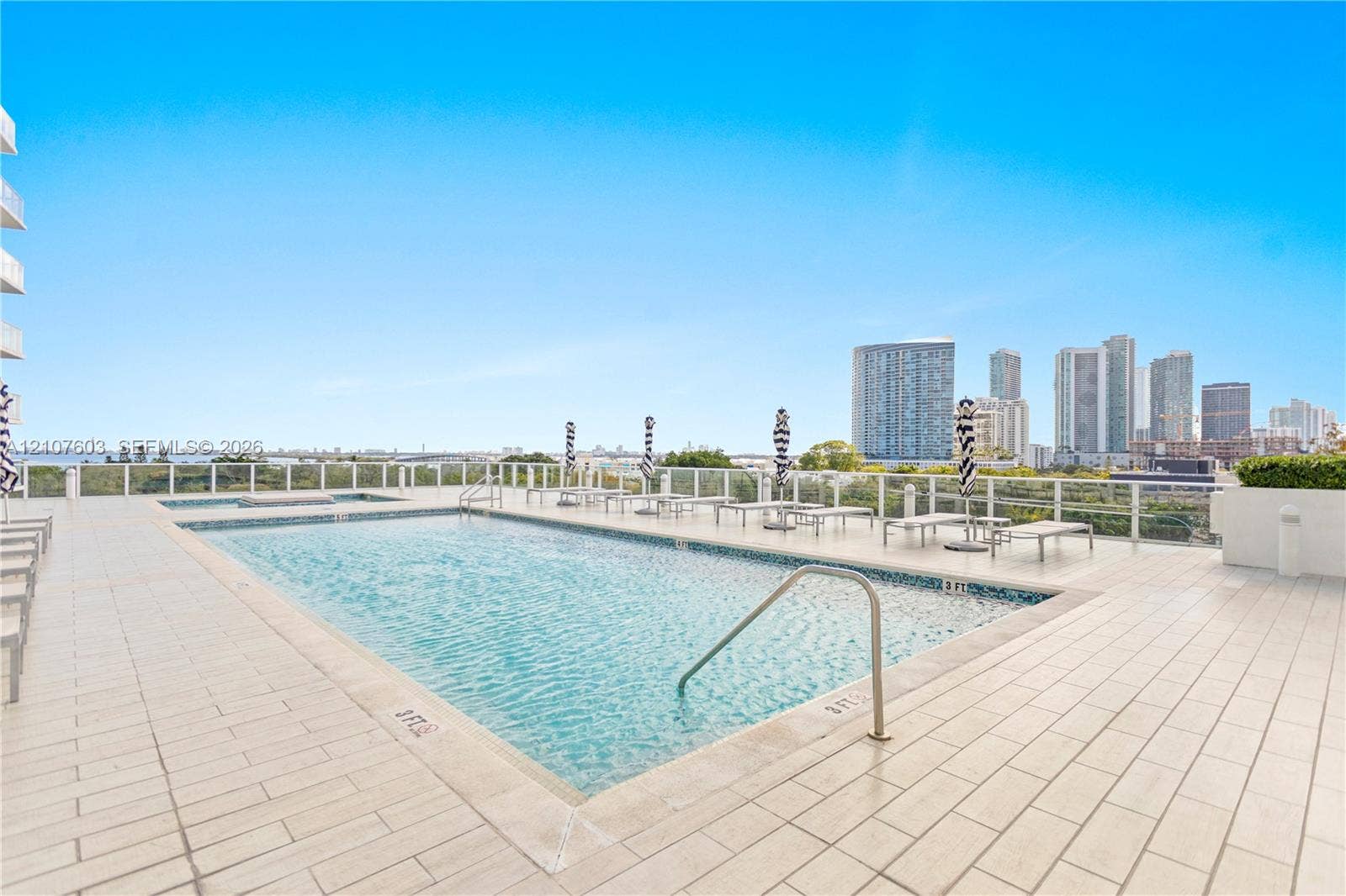 4250 Biscayne Boulevard, #1418, Miami, FL 33137 Rooftop swimming pool with tile decking, metal handrails, and glass panel perimeter fencing