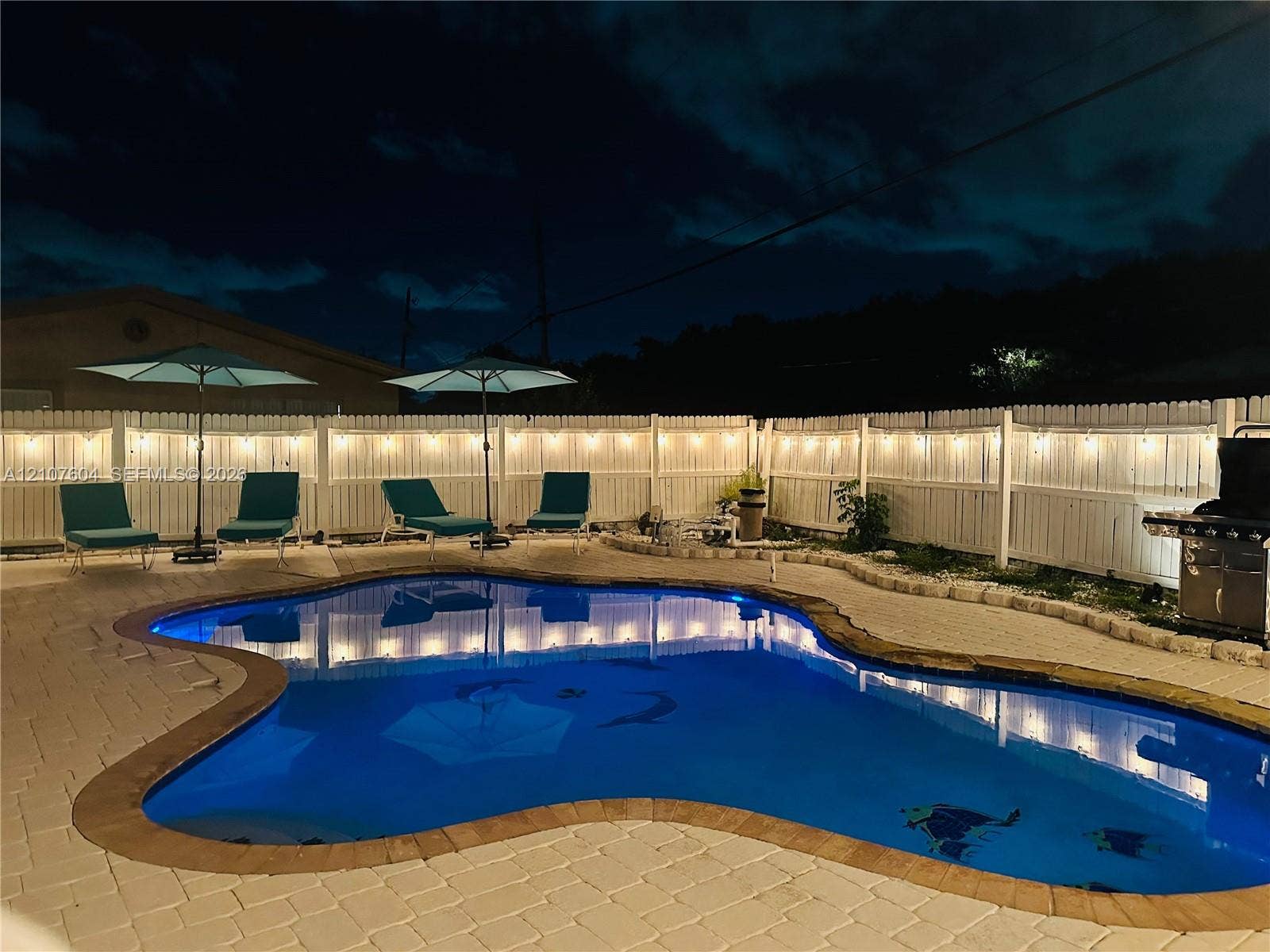 120 S 56th Avenue, Hollywood, Hollywood, FL 33023 Freeform swimming pool with stone coping, paver patio, and privacy fencing