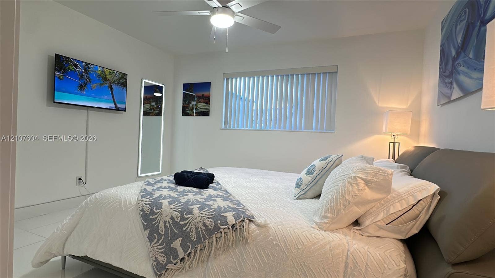 120 S 56th Avenue, Hollywood, Hollywood, FL 33023 Neutral-toned interior featuring white tile flooring, a ceiling fan with integrated lighting, and vertical blinds