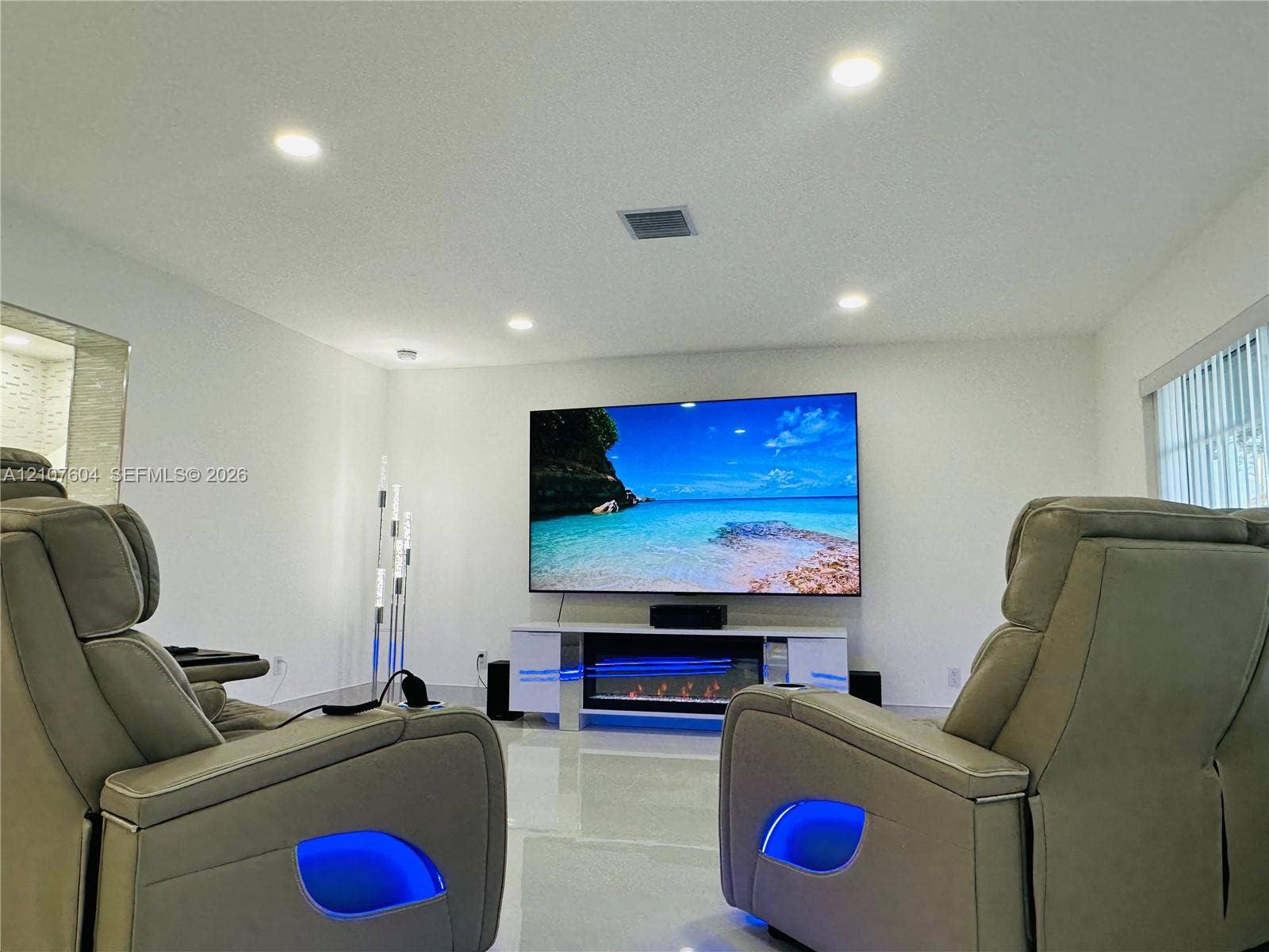 120 S 56th Avenue, Hollywood, Hollywood, FL 33023 Recessed ceiling lighting, polished flooring, and a built-in electric fireplace unit with a high-gloss finish