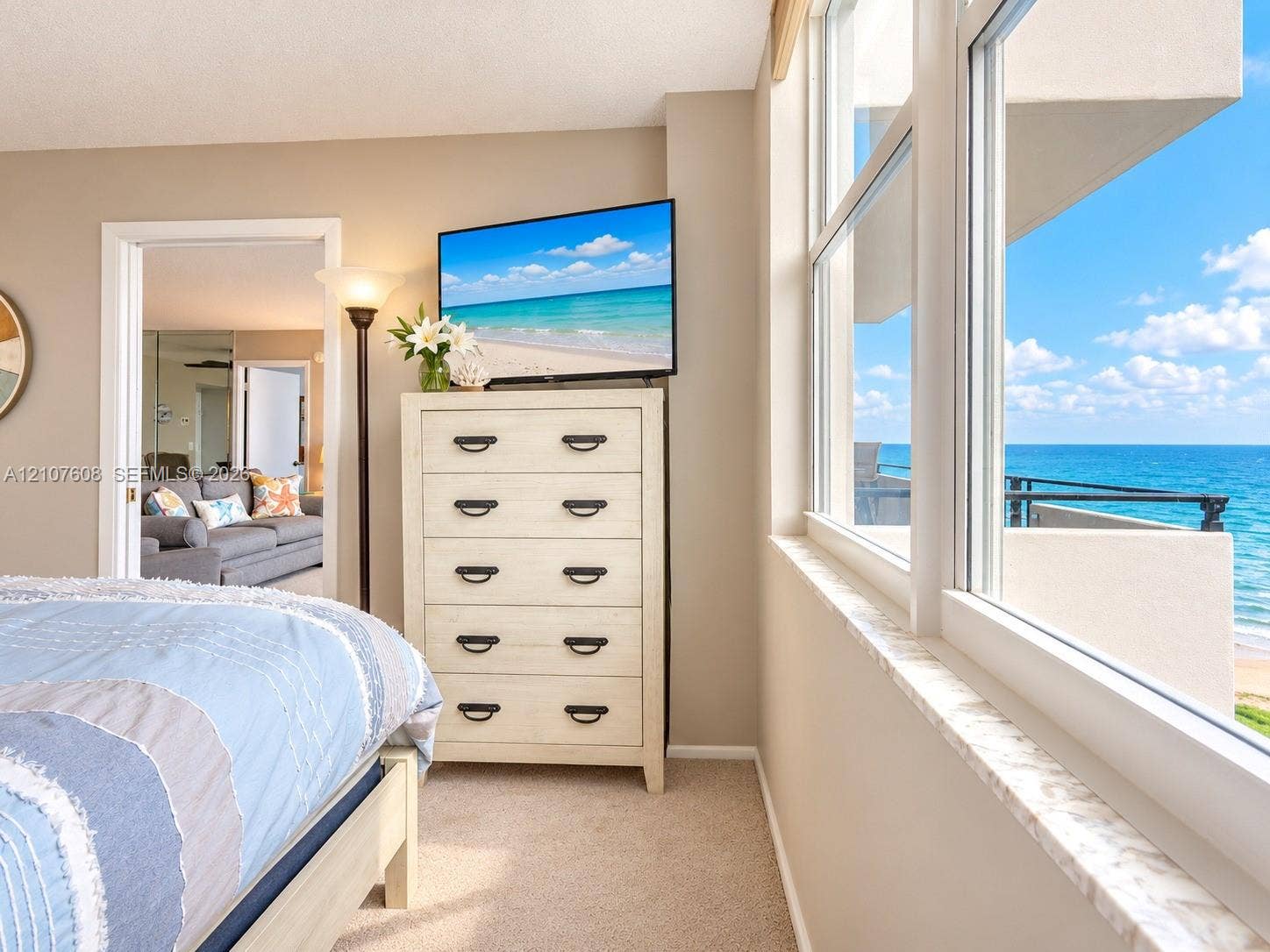 2000 S Ocean Boulevard, #12F, Lauderdale-By-The-Sea, Lauderdale By The Sea, FL 33062 Expansive windows featuring a marble sill, neutral carpeting, and an open-air balcony