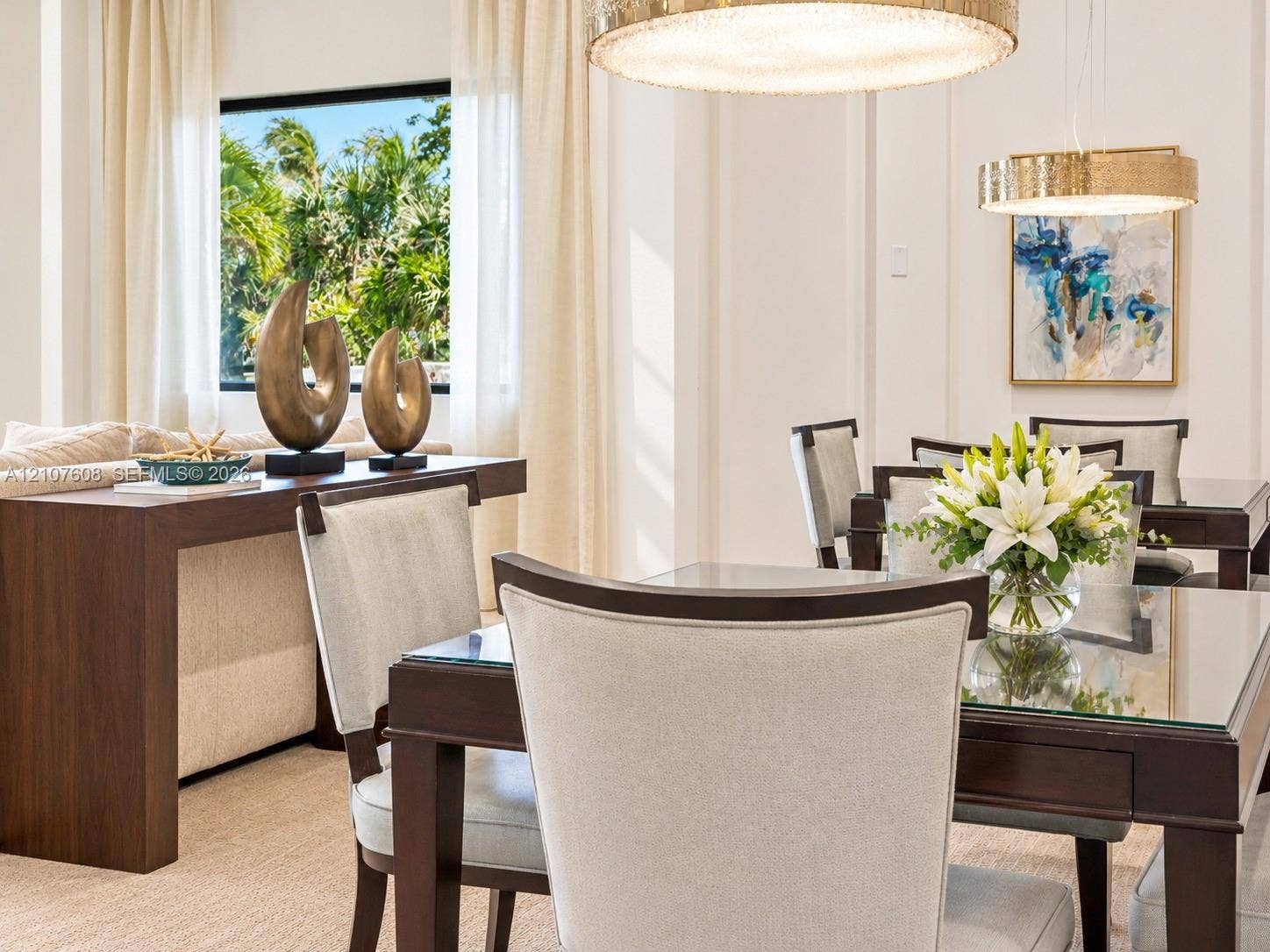 2000 S Ocean Boulevard, #12F, Lauderdale-By-The-Sea, Lauderdale By The Sea, FL 33062 High ceilings with crown molding, dual gold-tone circular pendant lights, and large windows with greenery