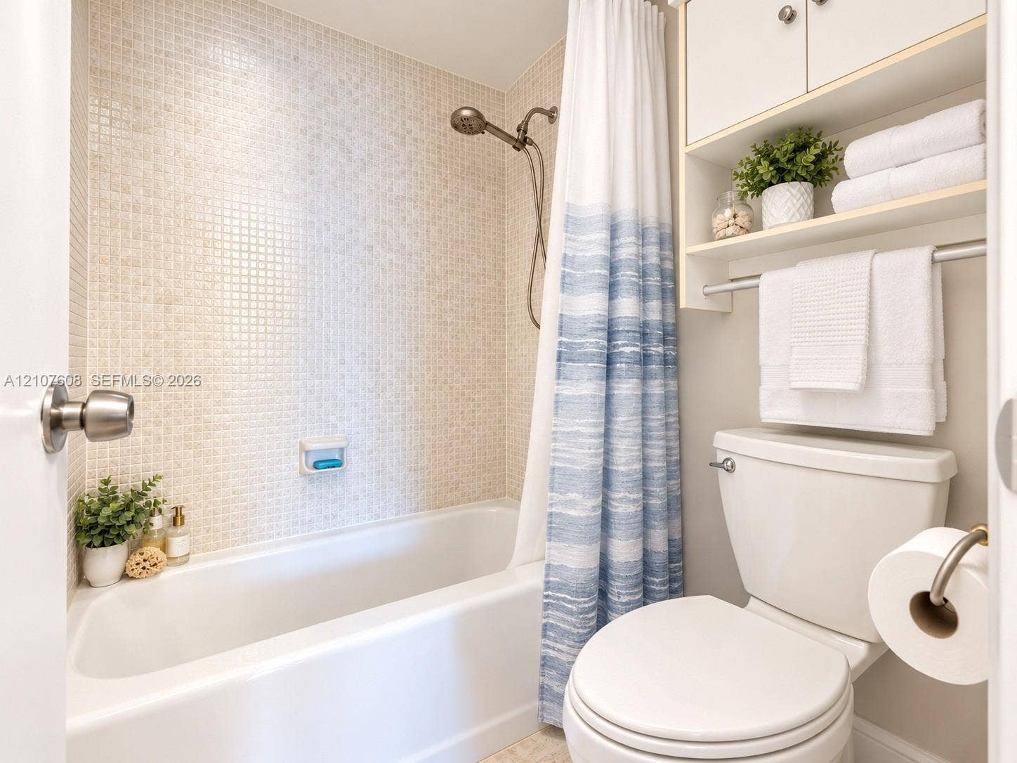 2000 S Ocean Boulevard, #12F, Lauderdale-By-The-Sea, Lauderdale By The Sea, FL 33062 Full-height tiled shower surround, integrated wall-mounted cabinetry with open shelving, chrome shower fixtures, and porcelain tub
