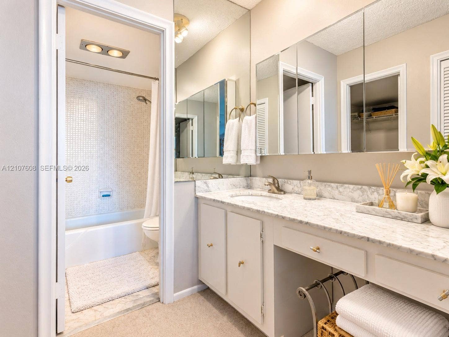 2000 S Ocean Boulevard, #12F, Lauderdale-By-The-Sea, Lauderdale By The Sea, FL 33062 Bathroom featuring a stone-top vanity with an integrated sink, full-width mirrored medicine cabinet, and a tiled shower-tub combination