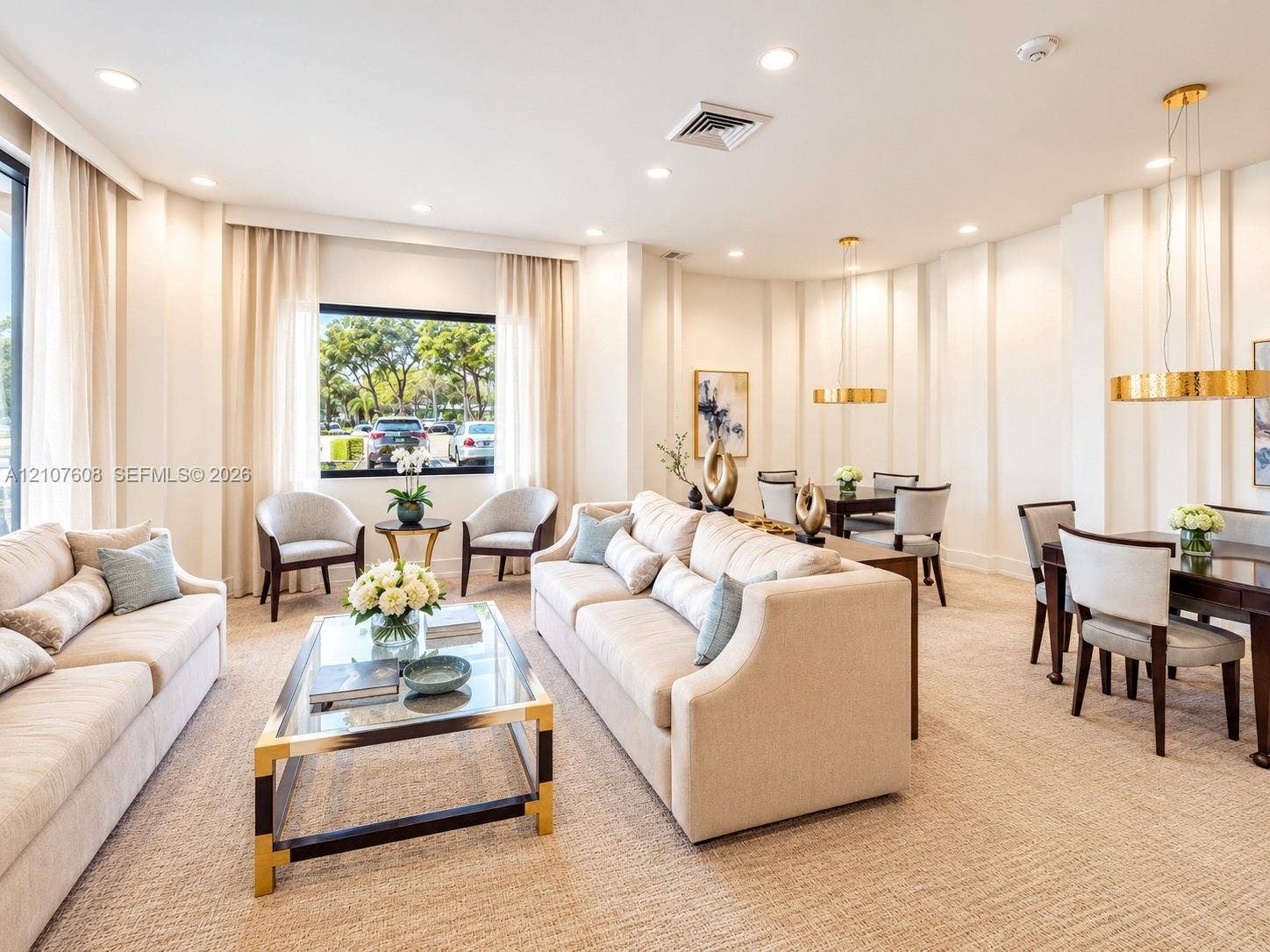 2000 S Ocean Boulevard, #12F, Lauderdale-By-The-Sea, Lauderdale By The Sea, FL 33062 Expansive living space featuring neutral-toned carpeting, recessed ceiling lighting, textured wall detailing, and dual circular gold-tone pendant fixtures
