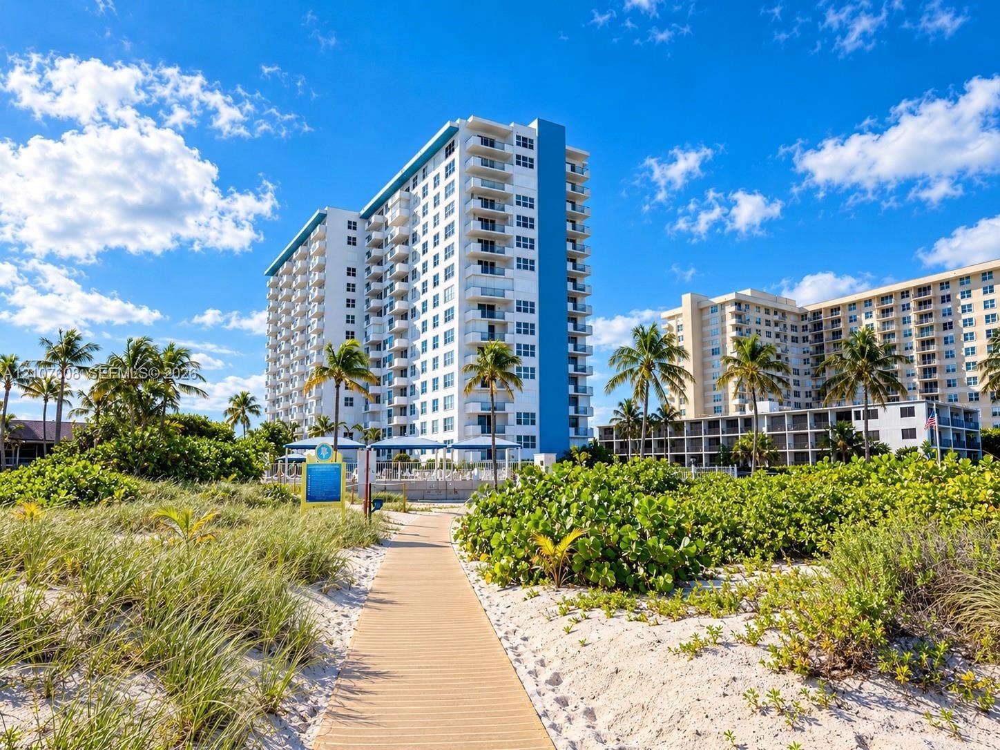 2000 S Ocean Boulevard, #12F, Lauderdale-By-The-Sea, Lauderdale By The Sea, FL 33062 High-rise residential exterior featuring private balconies and a paved beach walkway surrounded by native coastal landscaping