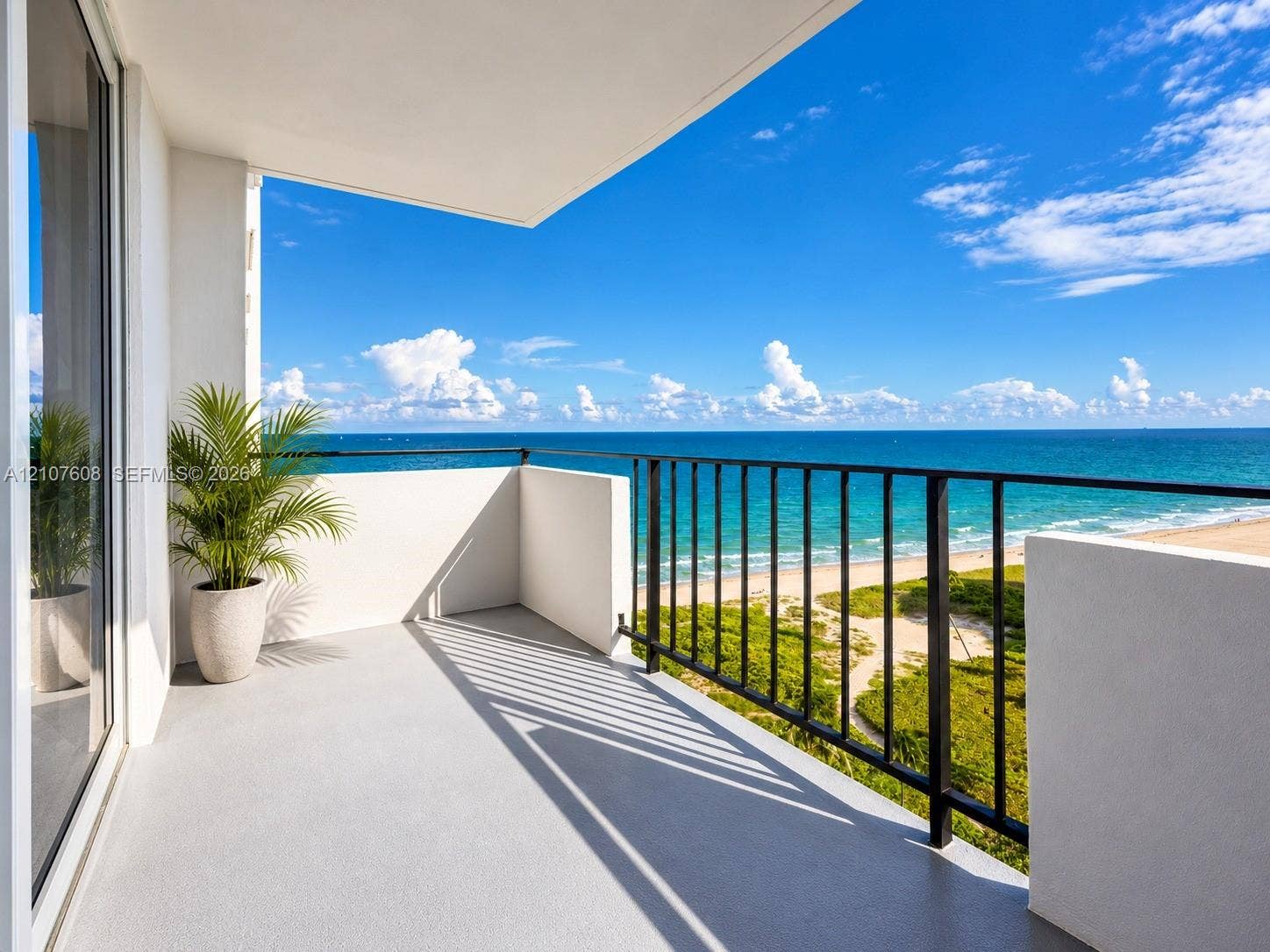 2000 S Ocean Boulevard, #12F, Lauderdale-By-The-Sea, Lauderdale By The Sea, FL 33062 Private balcony featuring a solid surface floor, black metal railing, and direct water frontage