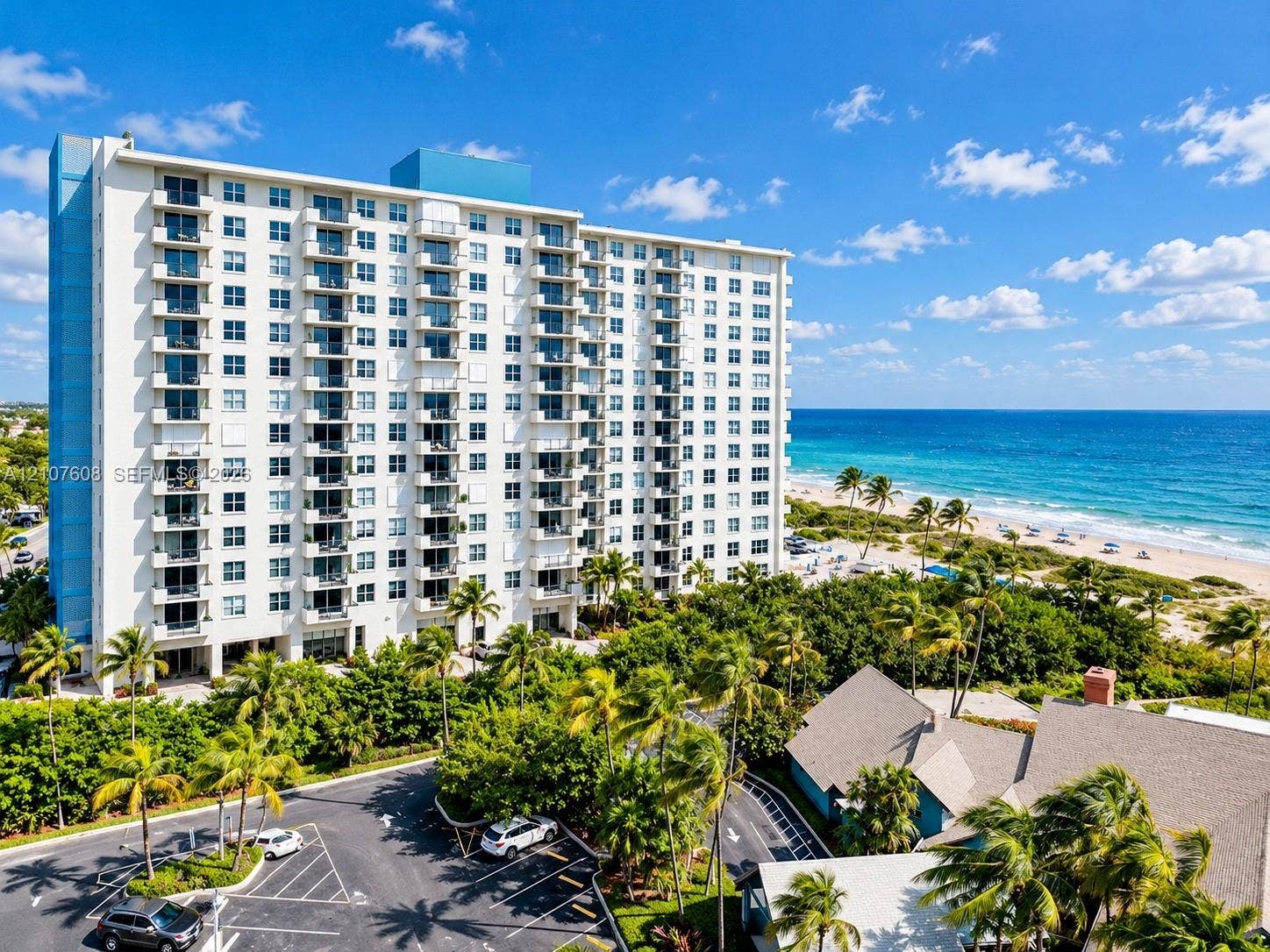 2000 S Ocean Boulevard, #12F, Lauderdale-By-The-Sea, Lauderdale By The Sea, FL 33062 High-rise residential building featuring private balconies, asphalt parking area, and direct proximity to the oceanfront