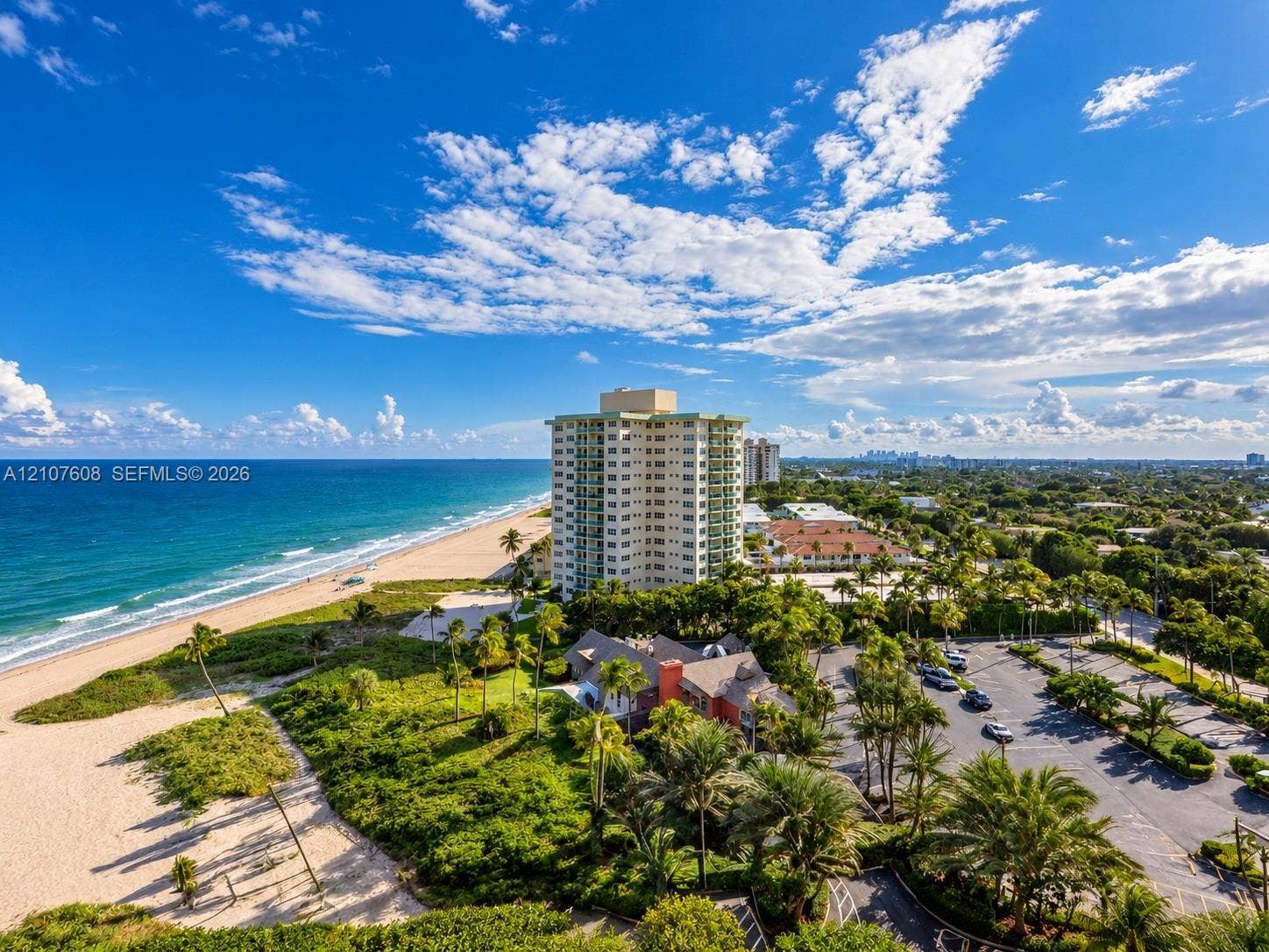 2000 S Ocean Boulevard, #12F, Lauderdale-By-The-Sea, Lauderdale By The Sea, FL 33062 Aerial perspective featuring direct oceanfront access, sandy shoreline, mature tropical landscaping, and paved parking area