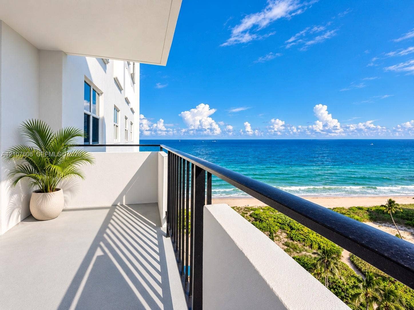 2000 S Ocean Boulevard, #12F, Lauderdale-By-The-Sea, Lauderdale By The Sea, FL 33062 Covered balcony featuring concrete flooring, black metal railing, and ocean horizon backdrop