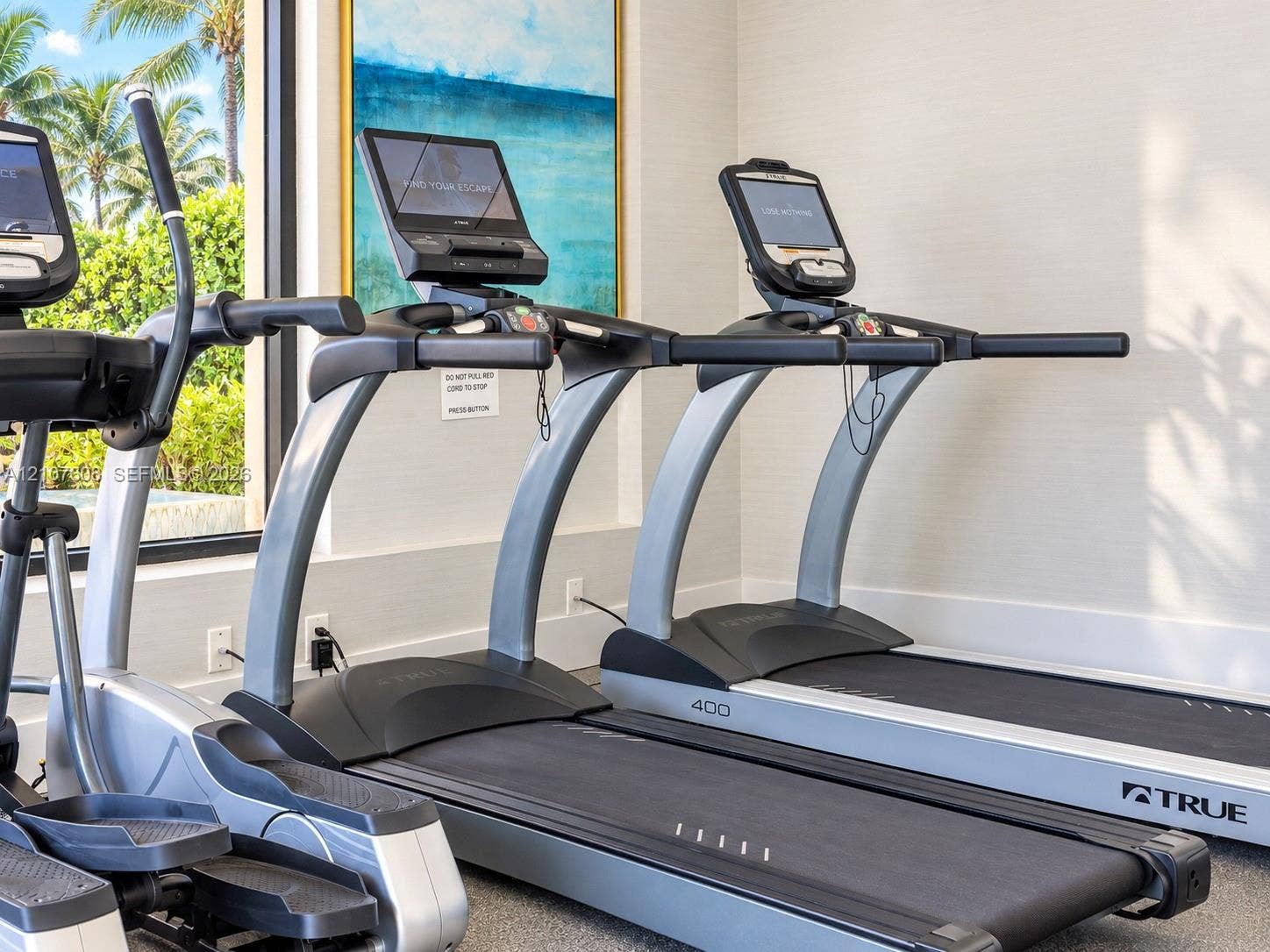 2000 S Ocean Boulevard, #12F, Lauderdale-By-The-Sea, Lauderdale By The Sea, FL 33062 Fitness center featuring professional-grade treadmills and elliptical equipment with integrated touch-screen displays and large windows providing natural light