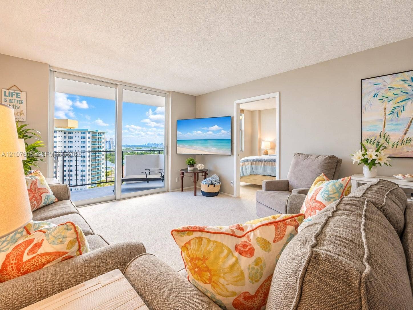 2000 S Ocean Boulevard, #12F, Lauderdale-By-The-Sea, Lauderdale By The Sea, FL 33062 Living space featuring wall-to-wall carpeting and floor-to-ceiling glass sliding doors opening to a private balcony