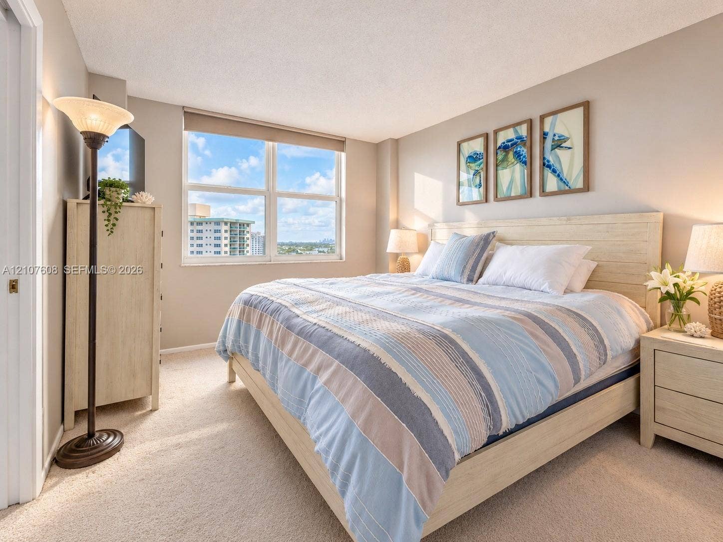 2000 S Ocean Boulevard, #12F, Lauderdale-By-The-Sea, Lauderdale By The Sea, FL 33062 Neutral-toned interior space featuring neutral wall paint, wall-to-wall carpeting, and a large multi-pane window with a roller shade