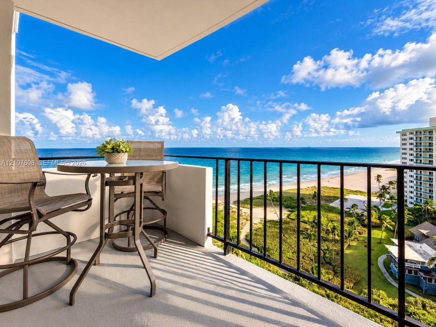 2000 S Ocean Boulevard, #12F, Lauderdale-By-The-Sea, Lauderdale By The Sea, FL 33062 Covered balcony featuring concrete flooring and a metal railing overlooking the coastline and ocean