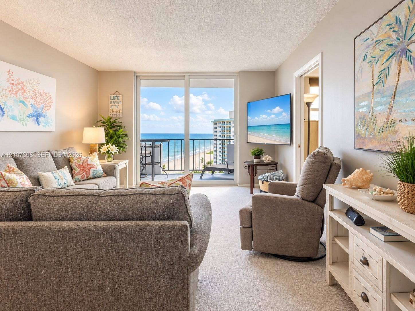 2000 S Ocean Boulevard, #12F, Lauderdale-By-The-Sea, Lauderdale By The Sea, FL 33062 Living area featuring full-height sliding glass doors leading to a private balcony with ocean frontage