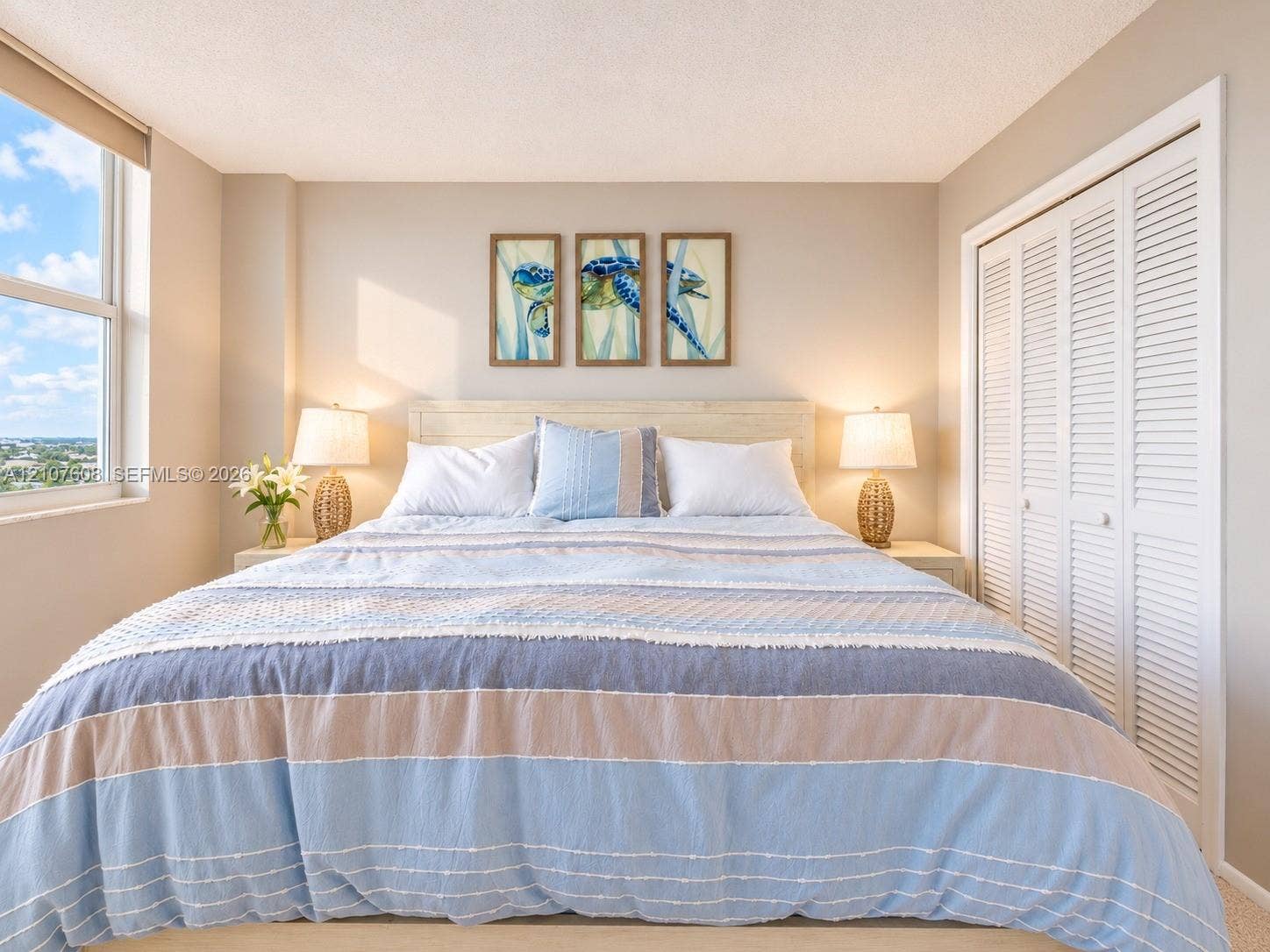 2000 S Ocean Boulevard, #12F, Lauderdale-By-The-Sea, Lauderdale By The Sea, FL 33062 Large window providing natural light, white louvered closet doors, and neutral wall tones