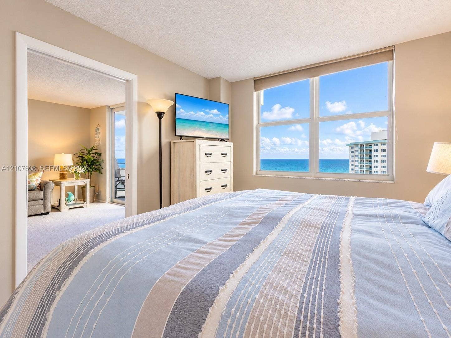 2000 S Ocean Boulevard, #12F, Lauderdale-By-The-Sea, Lauderdale By The Sea, FL 33062 Large windows with ocean horizon and coastal scenery, wall-to-wall carpeting, and sliding glass door