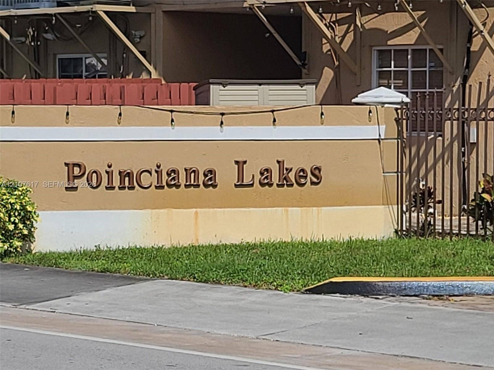 17415 NW 75th Place, #103, Hialeah, Hialeah, FL 33015 Stucco monument signage featuring dimensional lettering, landscaped greenery, and iron fencing