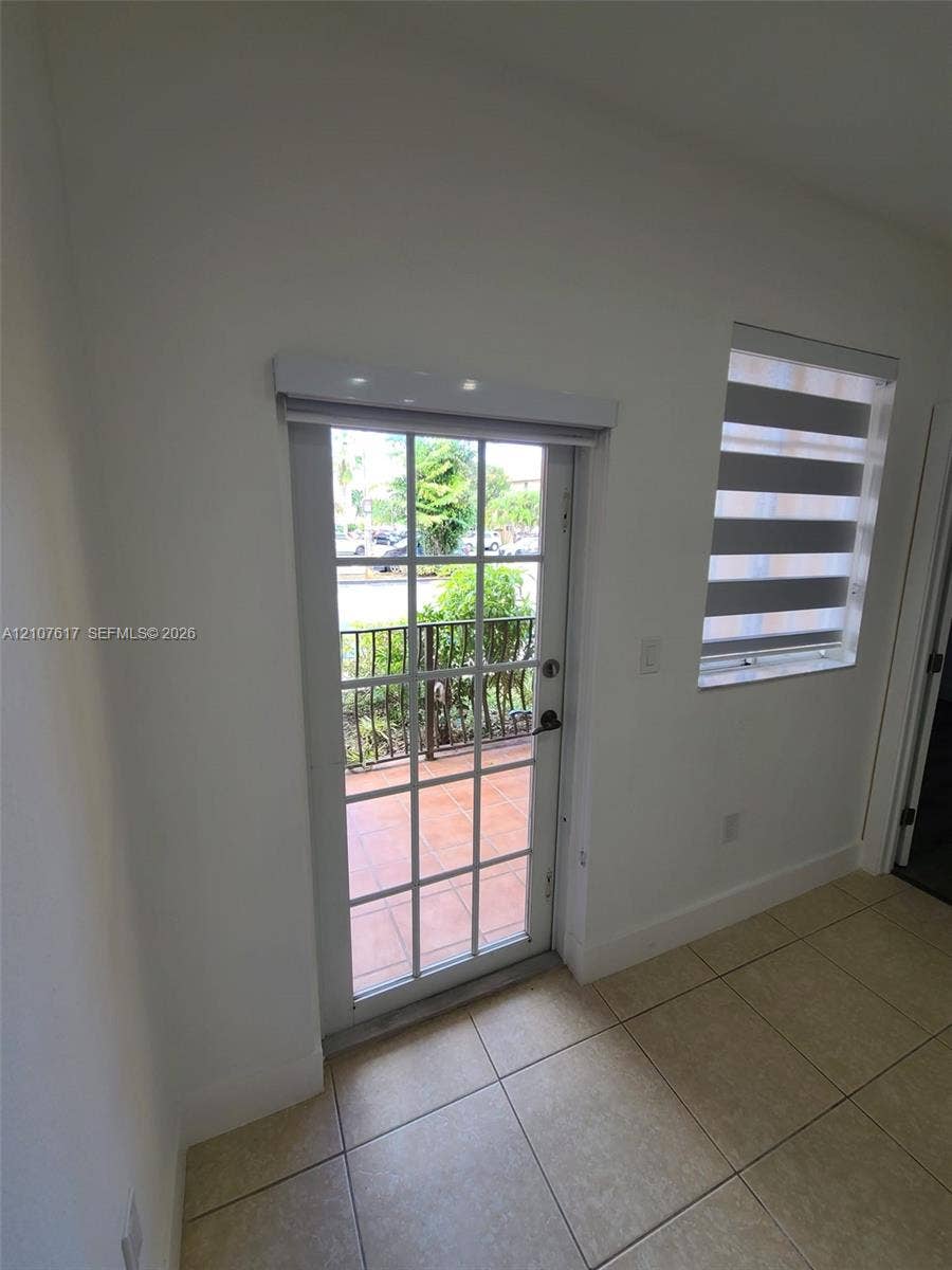 17415 NW 75th Place, #103, Hialeah, Hialeah, FL 33015 Full-light glass paneled door, tile flooring, and dual-layered roller window treatments