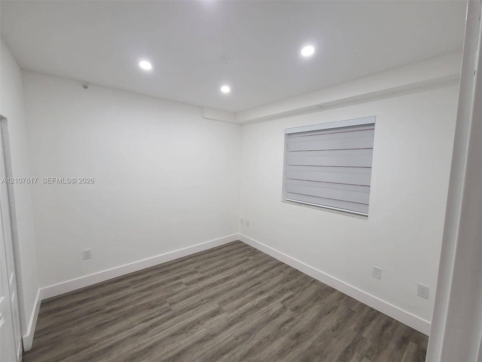 17415 NW 75th Place, #103, Hialeah, Hialeah, FL 33015 Interior room featuring wood-finish flooring, recessed lighting, and a window with a fitted roller shade