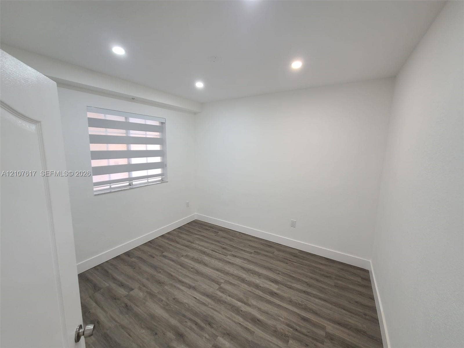 17415 NW 75th Place, #103, Hialeah, Hialeah, FL 33015 Interior room featuring wood-finish flooring, recessed lighting, and a window with horizontal shade blinds