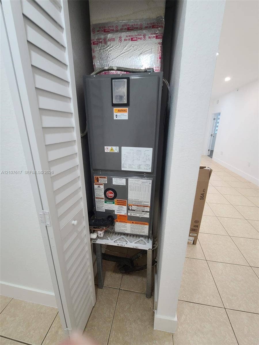 17415 NW 75th Place, #103, Hialeah, Hialeah, FL 33015 Utility closet featuring a central HVAC air handler unit enclosed by louvered bi-fold doors