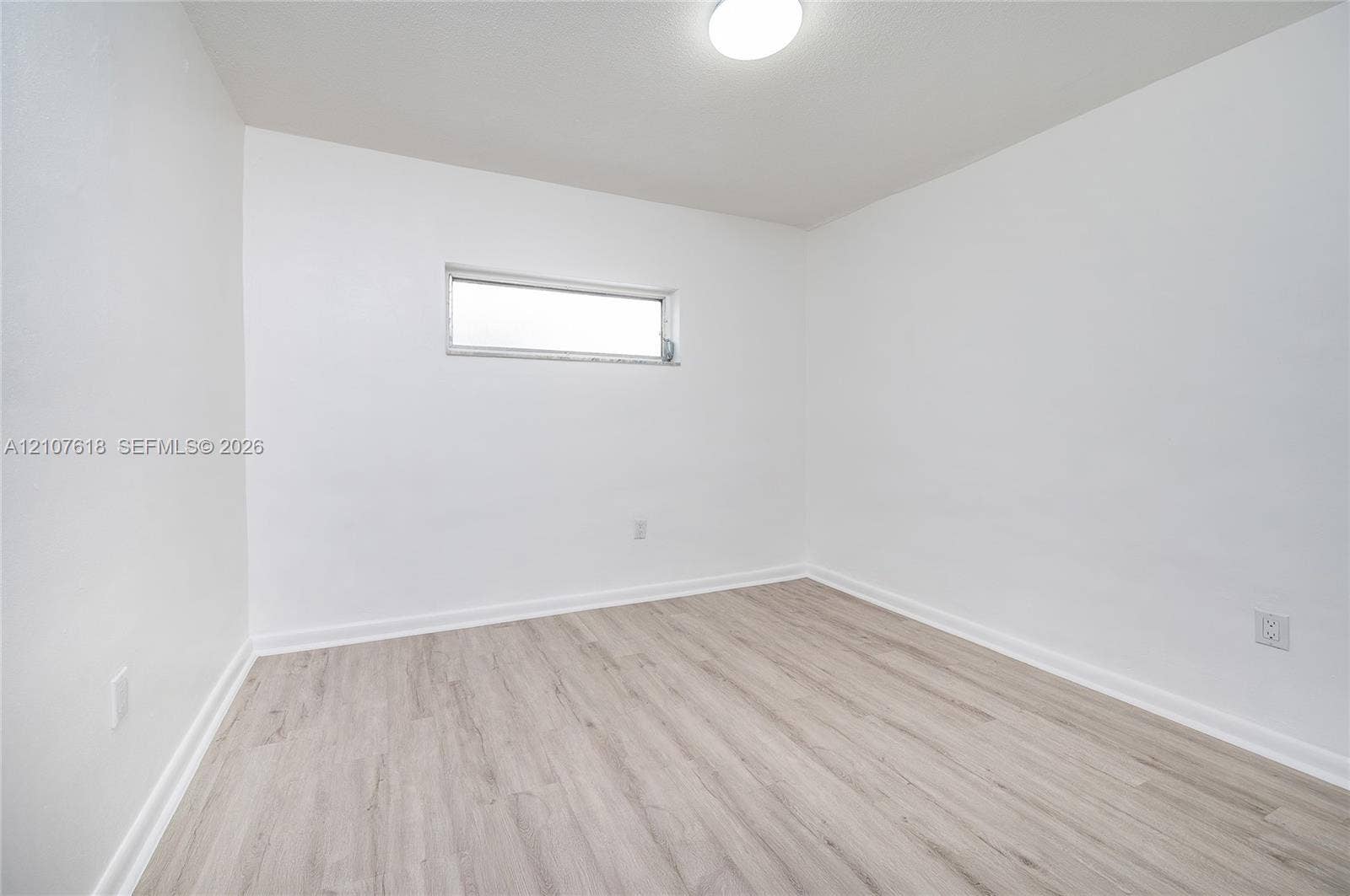 444 SW 27th Avenue, #46, Miami, Miami, FL 33135 Neutral-toned wood-finish flooring, crisp white walls, and a recessed ceiling light fixture