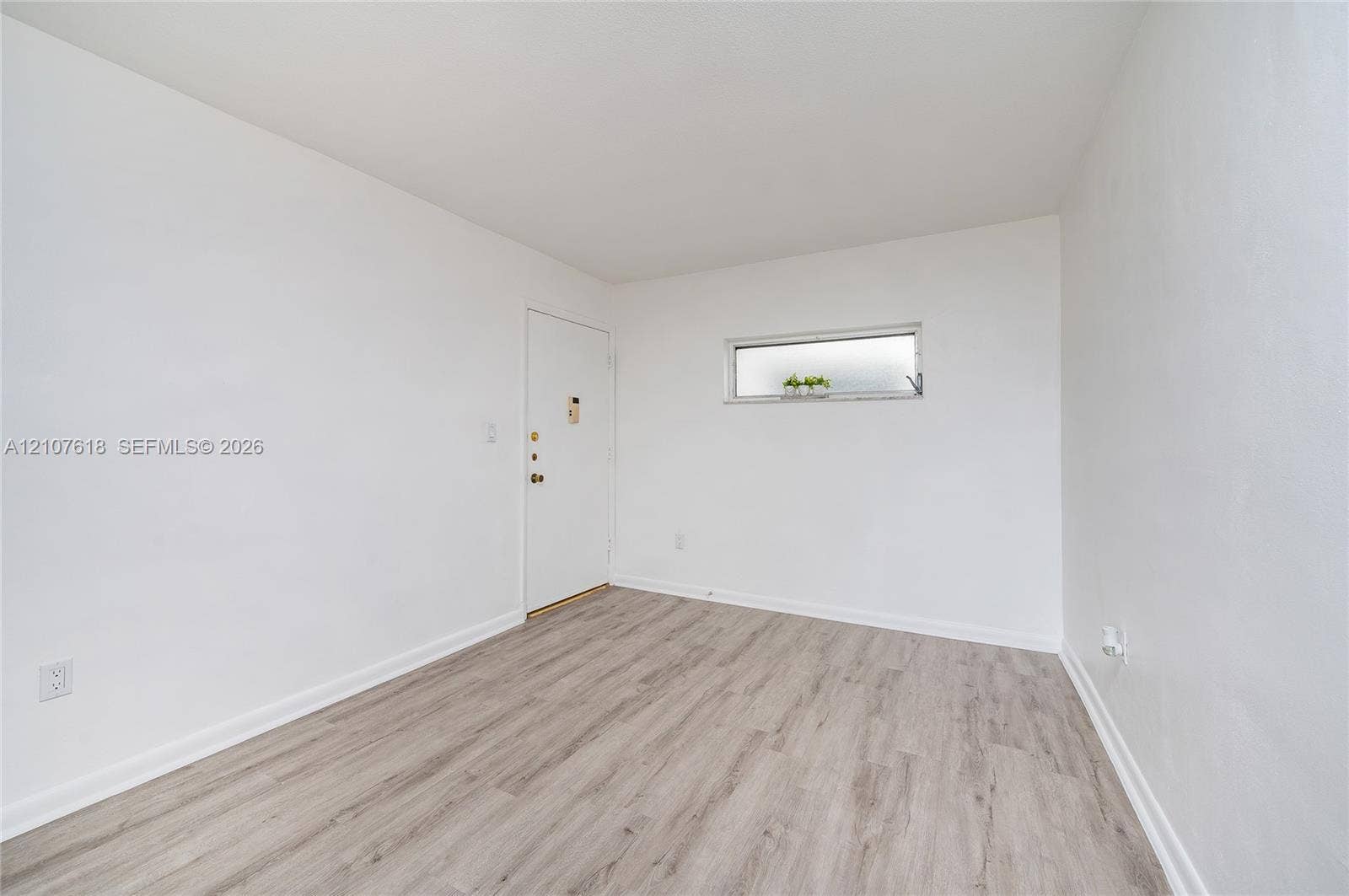 444 SW 27th Avenue, #46, Miami, Miami, FL 33135 Neutral-toned wood-finish flooring and a horizontal clerestory window