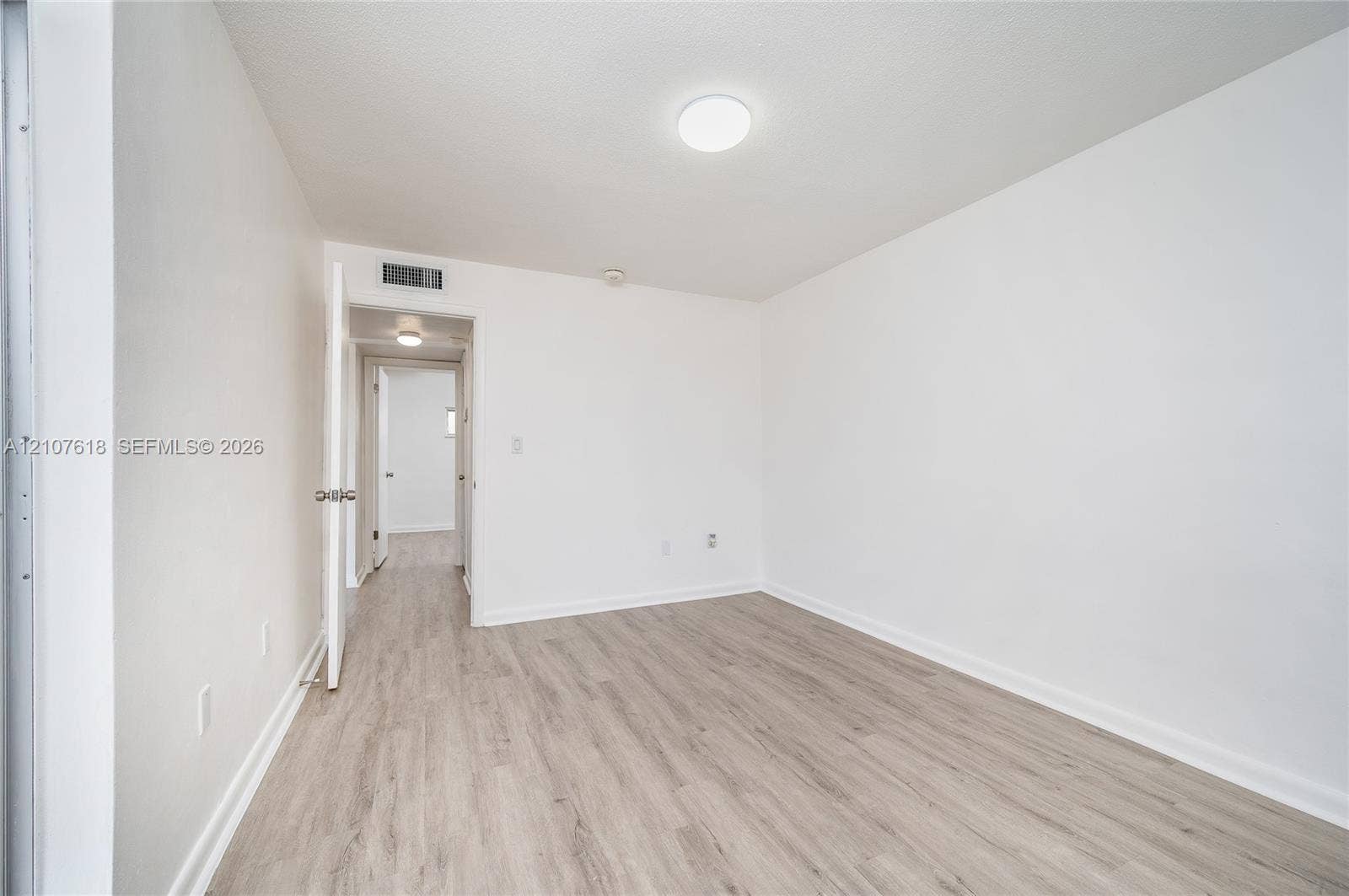 444 SW 27th Avenue, #46, Miami, Miami, FL 33135 Interior room featuring wood-finish flooring, white walls, and a flush-mount ceiling light fixture