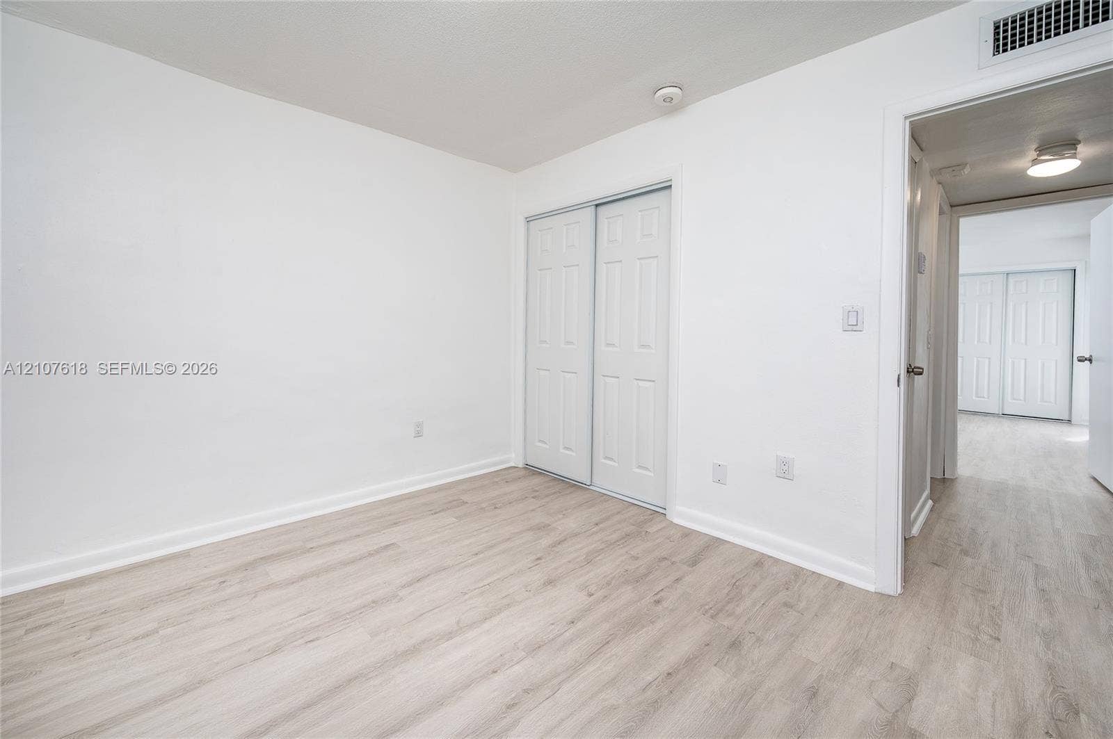 444 SW 27th Avenue, #46, Miami, Miami, FL 33135 Room featuring wood-finish flooring, white walls, and a closet with dual-panel sliding doors