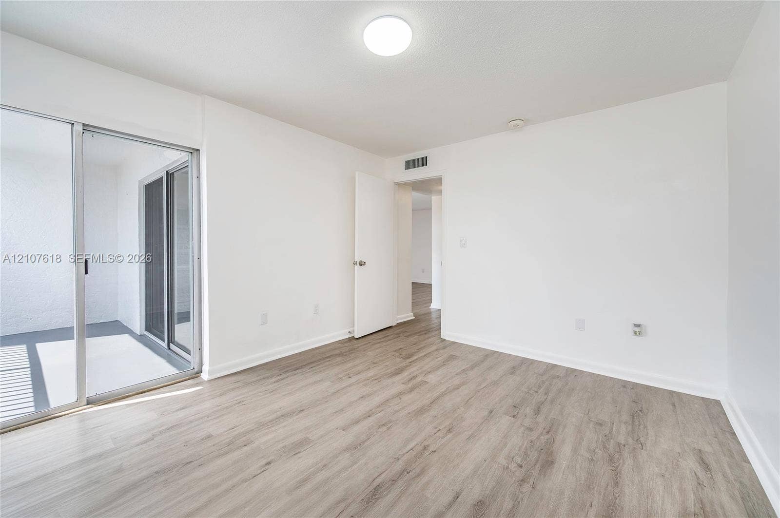 444 SW 27th Avenue, #46, Miami, Miami, FL 33135 Interior space featuring wood-finish flooring, sliding glass door, and flush-mount lighting