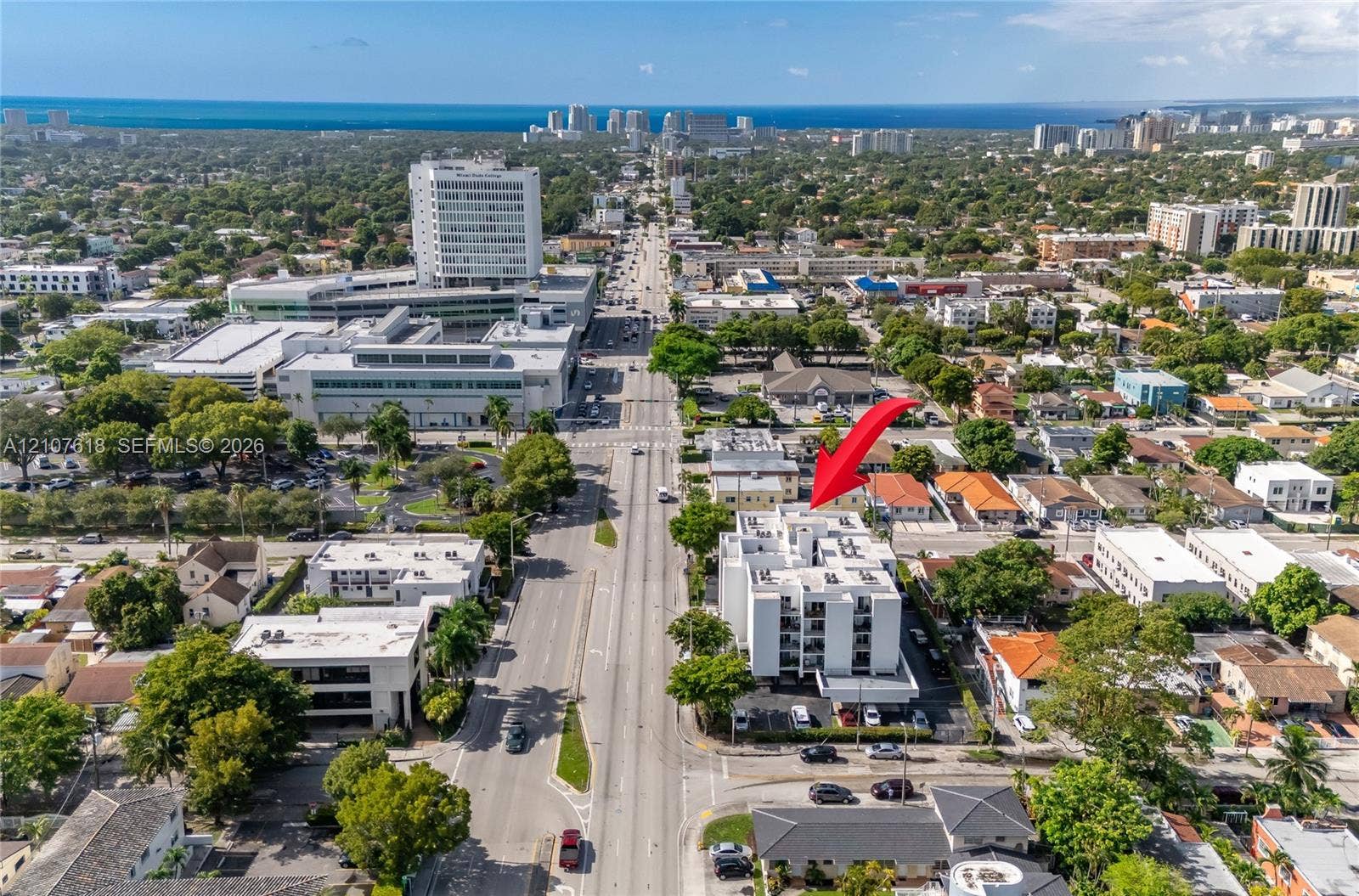 444 SW 27th Avenue, #46, Miami, Miami, FL 33135 Aerial perspective of a multi-story residential building featuring a white facade, flat roofline, and ground-level surface parking