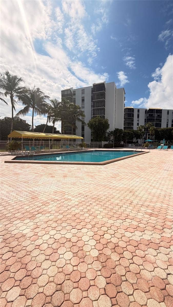 20400 W Country Club Drive, #112, Aventura, FL 33180 Outdoor pool featuring concrete paver decking and a covered shaded area