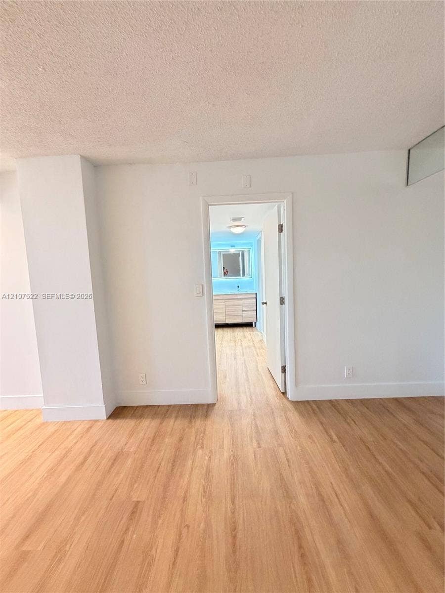 20400 W Country Club Drive, #112, Aventura, FL 33180 Wood-finish flooring throughout, featuring a single-panel interior door and a vanity with cabinetry