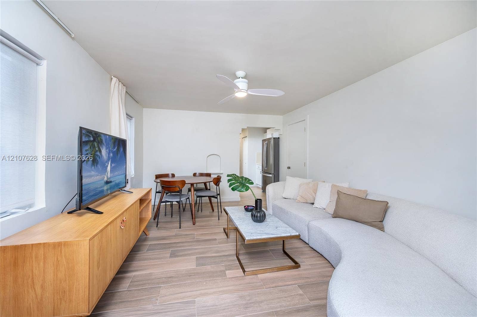 217 Madeira Avenue, #1, Coral Gables, Coral Gables, FL 33134 Living space featuring wood-finish flooring, white walls, and a ceiling-mounted light fixture with fan