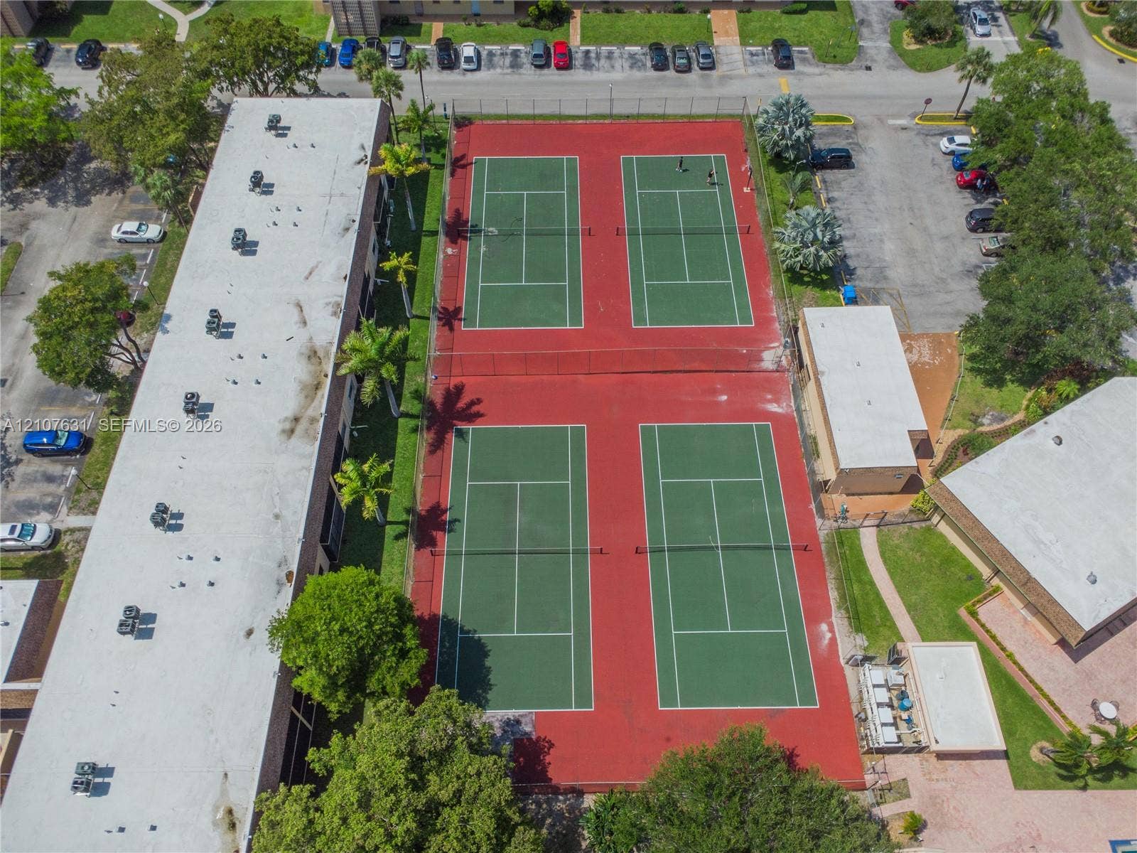 151 Berkley Road, #112, Hollywood, FL 33024 Four fenced outdoor tennis courts featuring painted hard-court surfaces and perimeter netting