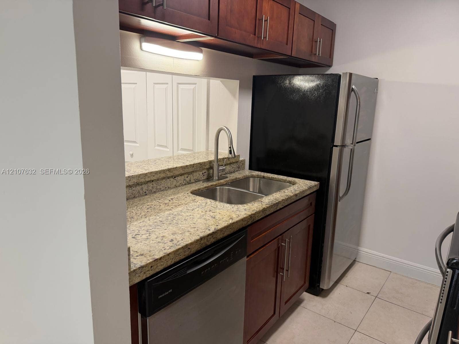 4501 W Mcnab Road, #13, Pompano Beach, Pompano Beach, FL 33069 Kitchen featuring stone-finish countertops, stainless steel dual-basin undermount sink with a gooseneck faucet, wooden cabinetry, stainless steel dishwasher, and stainless steel refrigerator