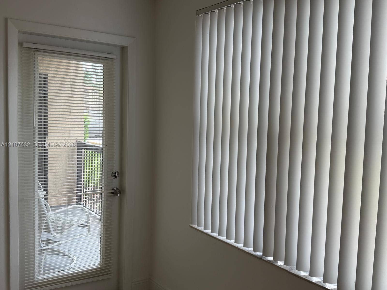 4501 W Mcnab Road, #13, Pompano Beach, Pompano Beach, FL 33069 Glass-paned door with integrated blinds, exterior balcony with railing, and vertical window blinds