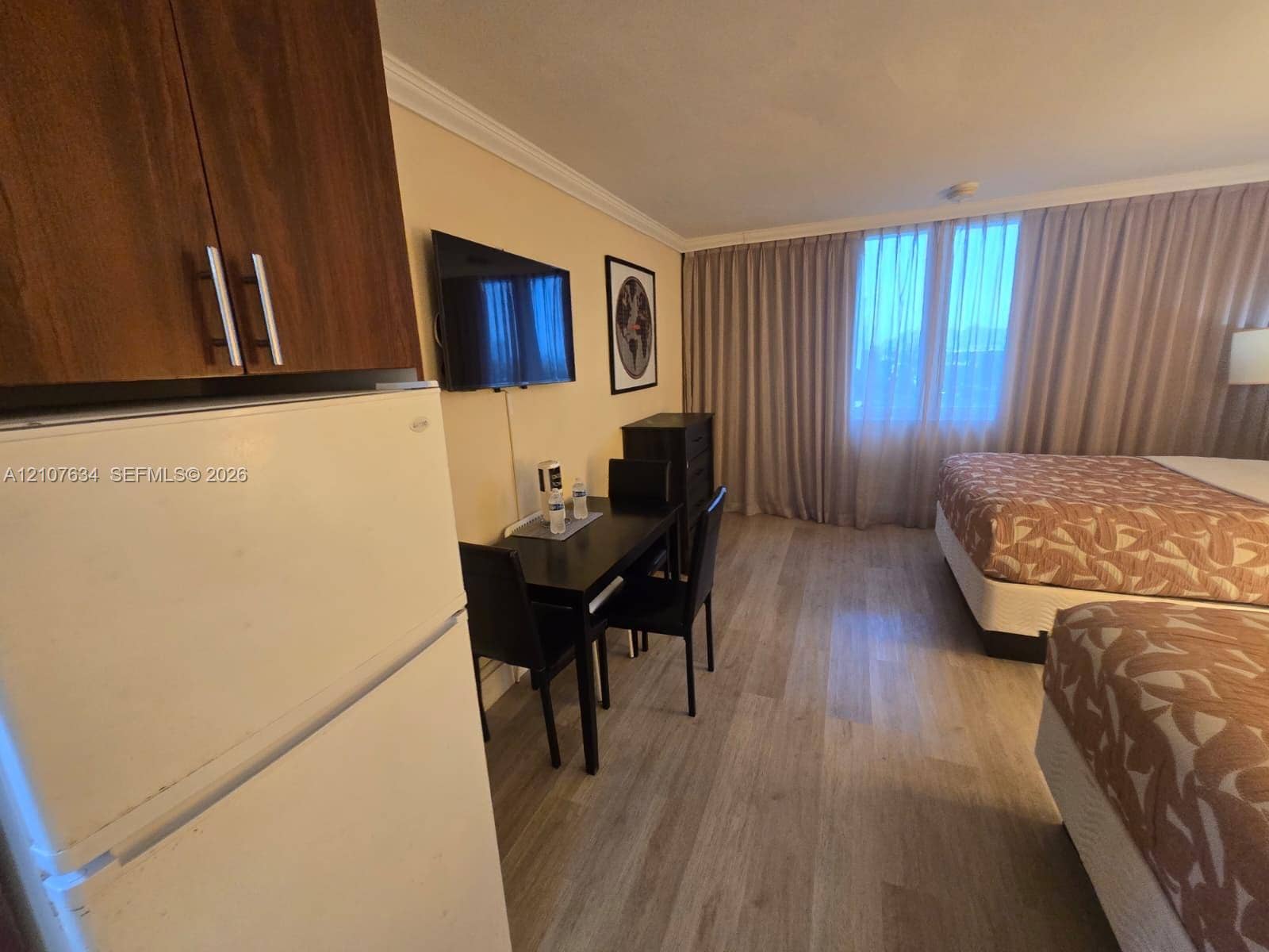 19201 Collins Avenue, #941, Sunny Isles Beach, FL 33160 Wood-finish flooring, full-height cabinetry with brushed metal hardware, and floor-to-ceiling window drapery
